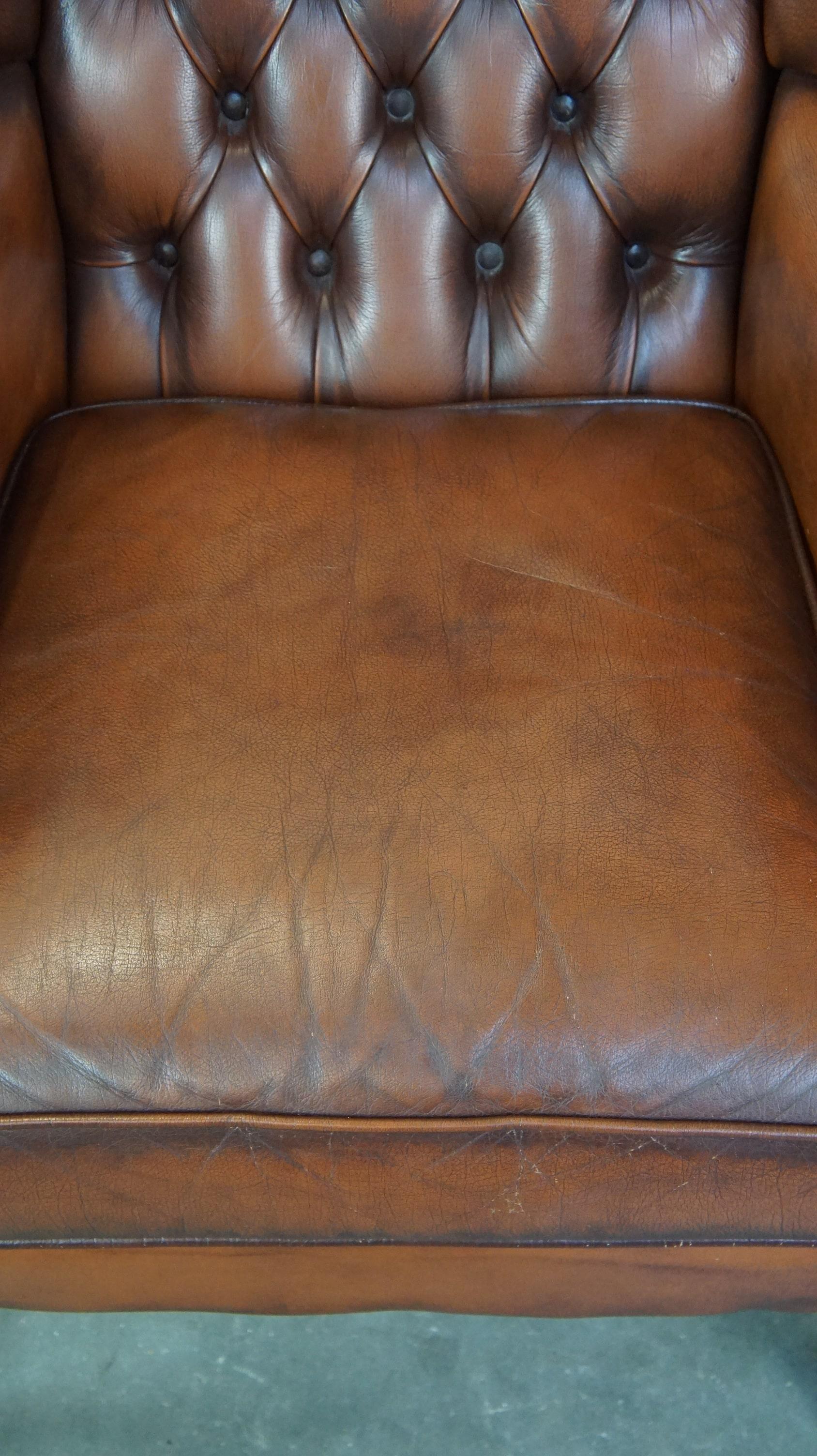 Cowhide Very beautiful cowhide Chesterfield wing chair with elegant legs in brown color For Sale