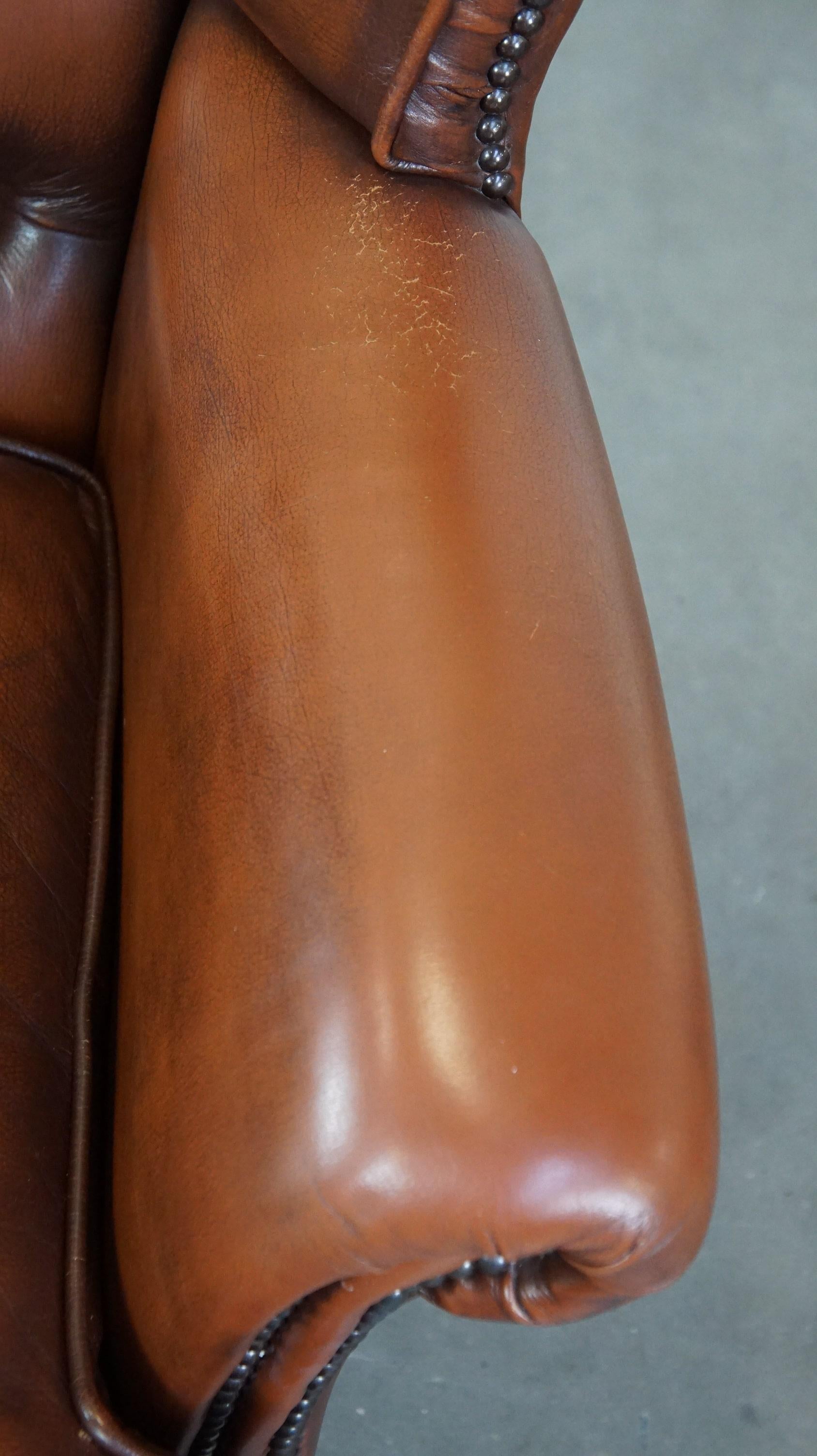 Very beautiful cowhide Chesterfield wing chair with elegant legs in brown color For Sale 2