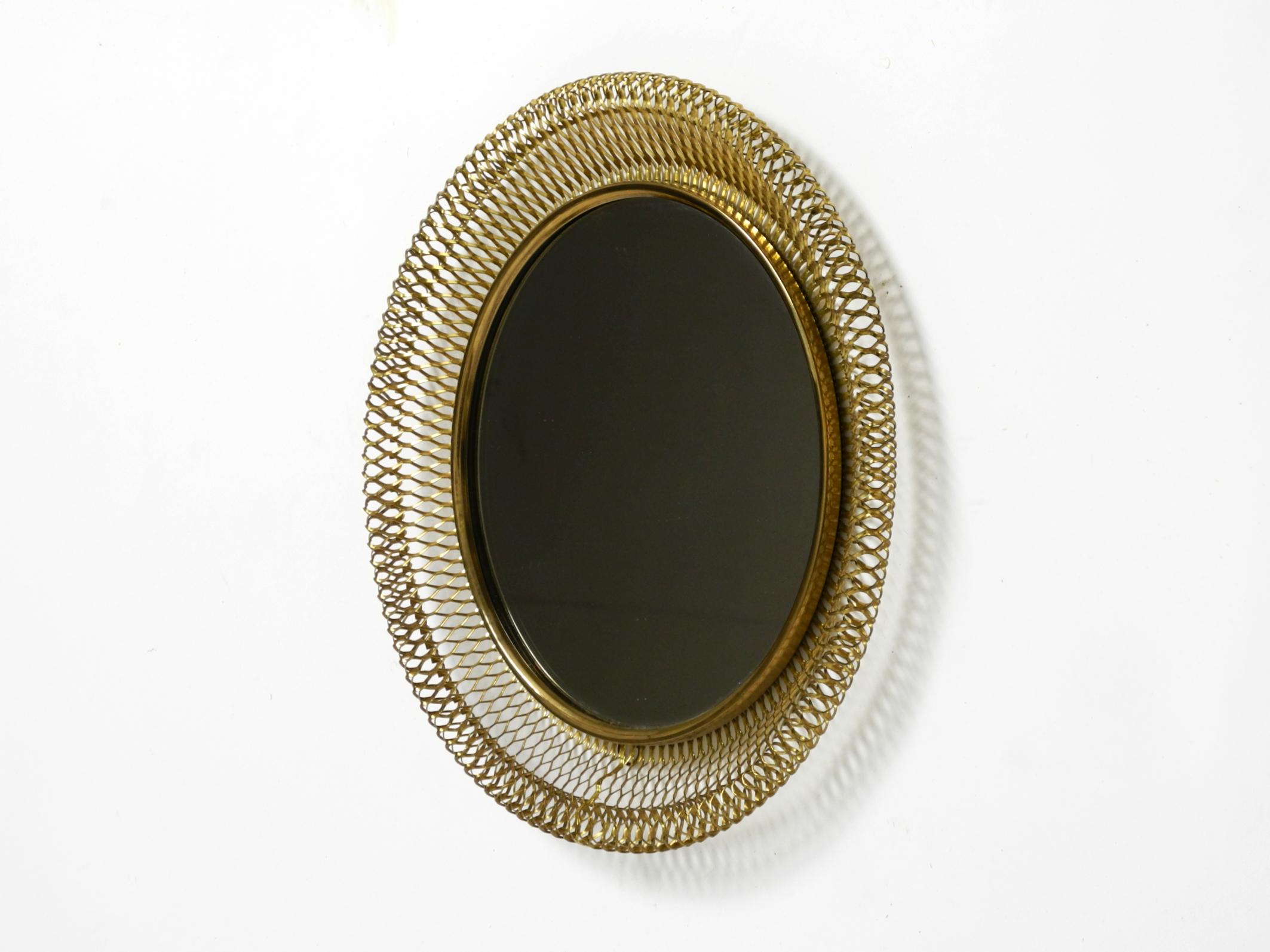 Mid-Century Modern Very beautiful Mid Century Modern wall mirror with expanded brass frame For Sale
