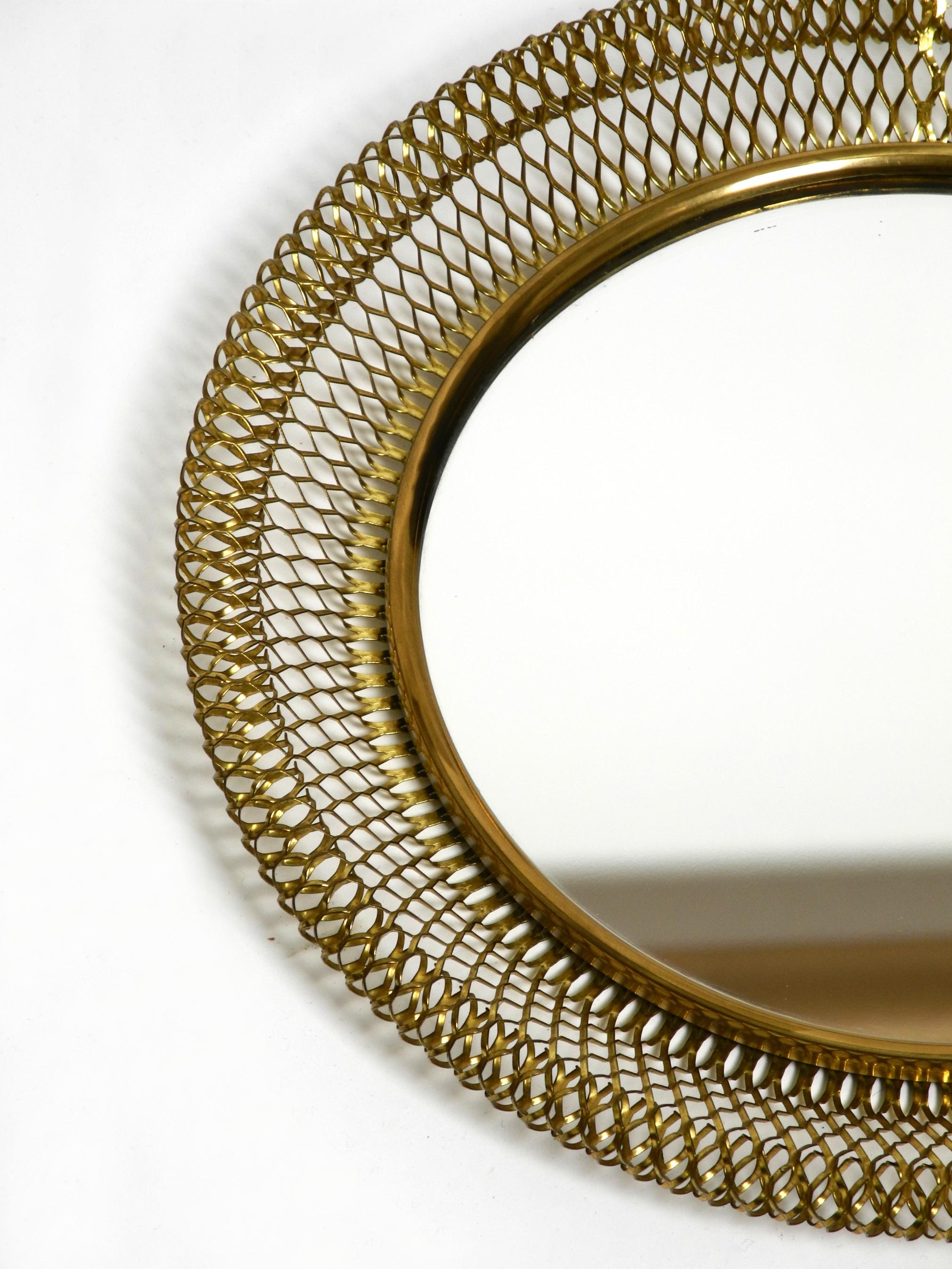 Metal Very beautiful Mid Century Modern wall mirror with expanded brass frame For Sale