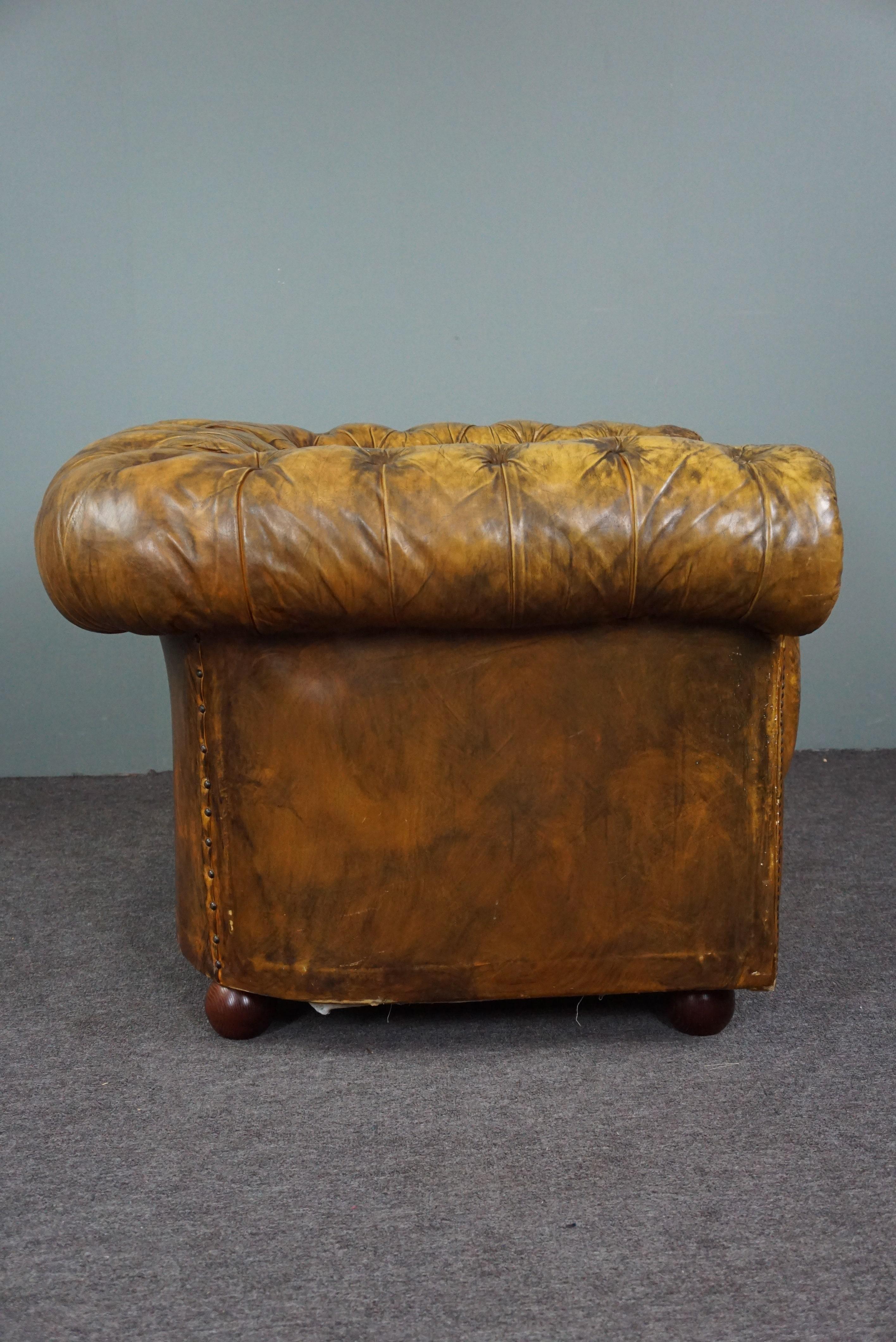 Offered is this wonderfully seated Chesterfield armchair with an amazing appearance due to its patina and color.

This imaginative patinated Chesterfield armchair has a padded back and armrests, a coil spring base and is still filled with horsehair,