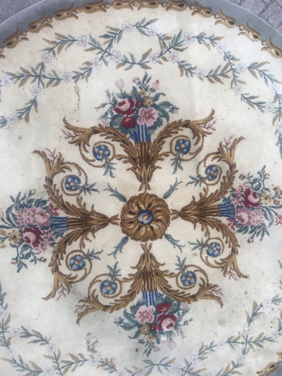 Discover the elegance of our exquisite fine European round rug featuring a stunning floral Savonnerie or Aubusson design, complemented by vibrant colors. This masterpiece is meticulously hand-knotted with luxurious wool velvet on a durable cotton