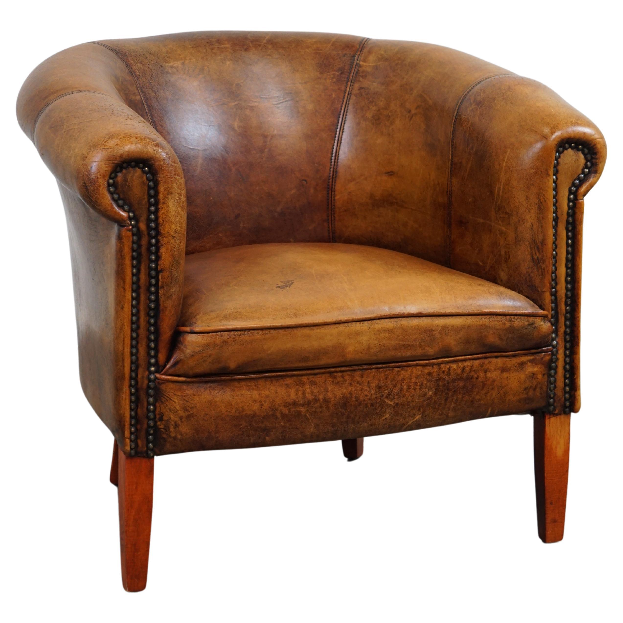 Very charming subtle sheep leather club armchair with beautiful colors and decor For Sale