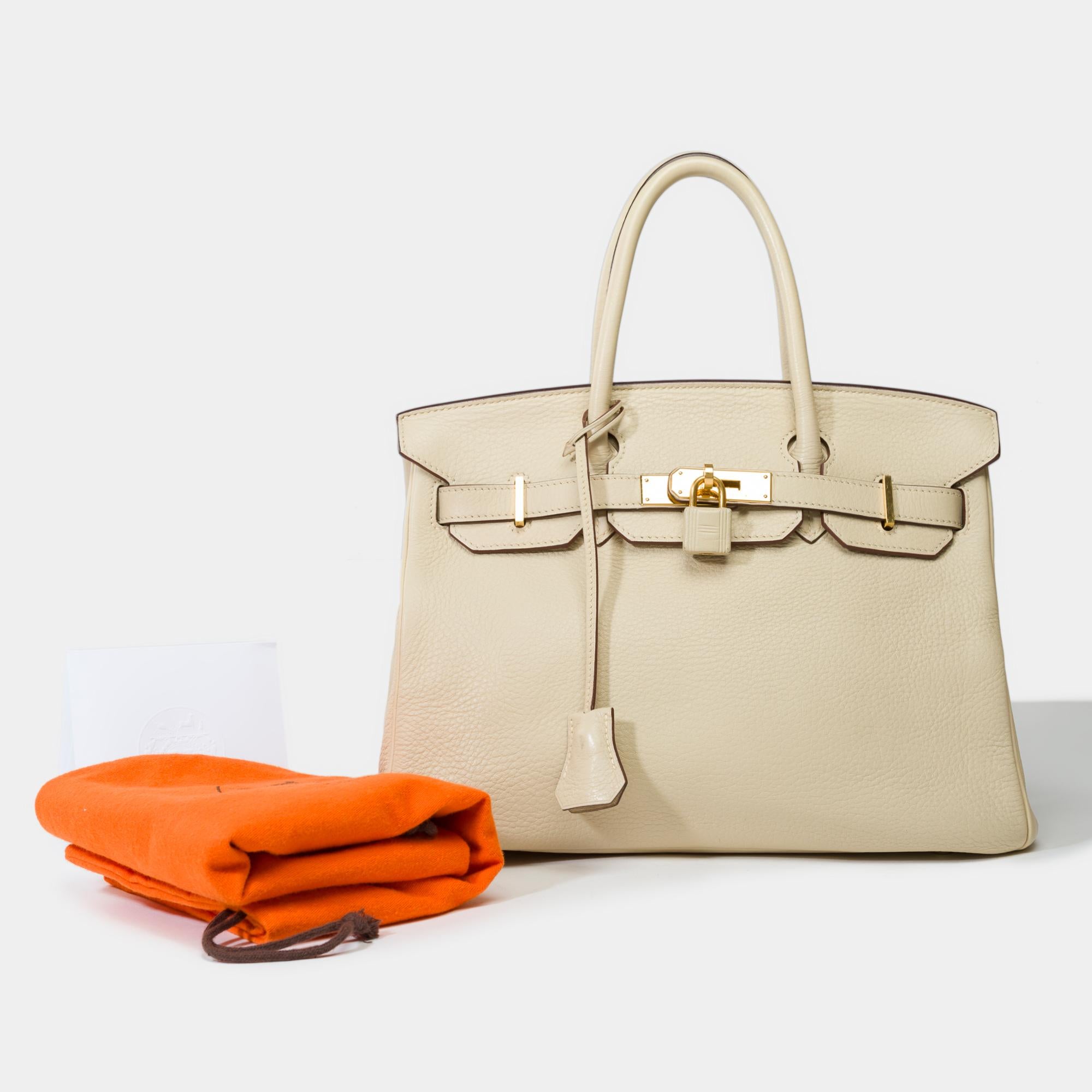 Stunning​ ​Hermes​ ​Birkin​ ​30​ ​in​ ​Parchemin​ ​Togo​ ​leather,​ ​gold​ ​plated​ ​metal​ ​trim​ ​,​ ​double​ ​handle​ ​in​ ​beige​ ​leather​ ​allowing​ ​a​ ​hand​ ​carry

Flap​ ​closure
Inner​ ​lining​ ​in​ ​beige​ ​leather​ ​,​ ​a​ ​zippered​