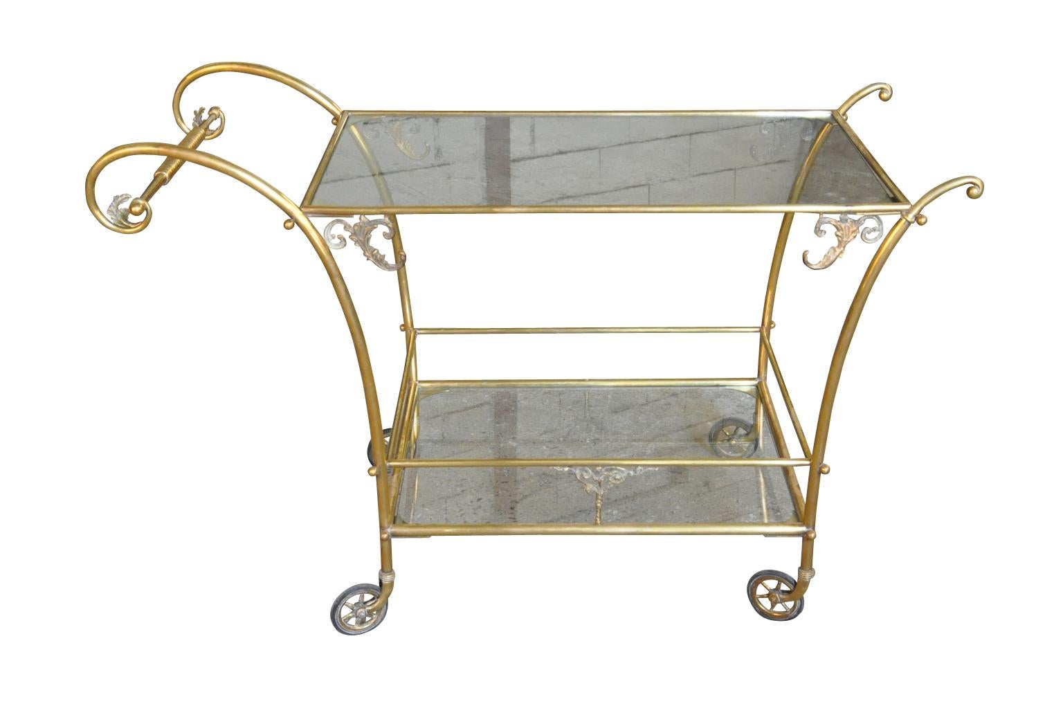 A very chic and lovely early 20th century cocktail cart from Northern Italy. Beautifully crafted from brass and glass. Please note that the two glass shelves are clear glass.