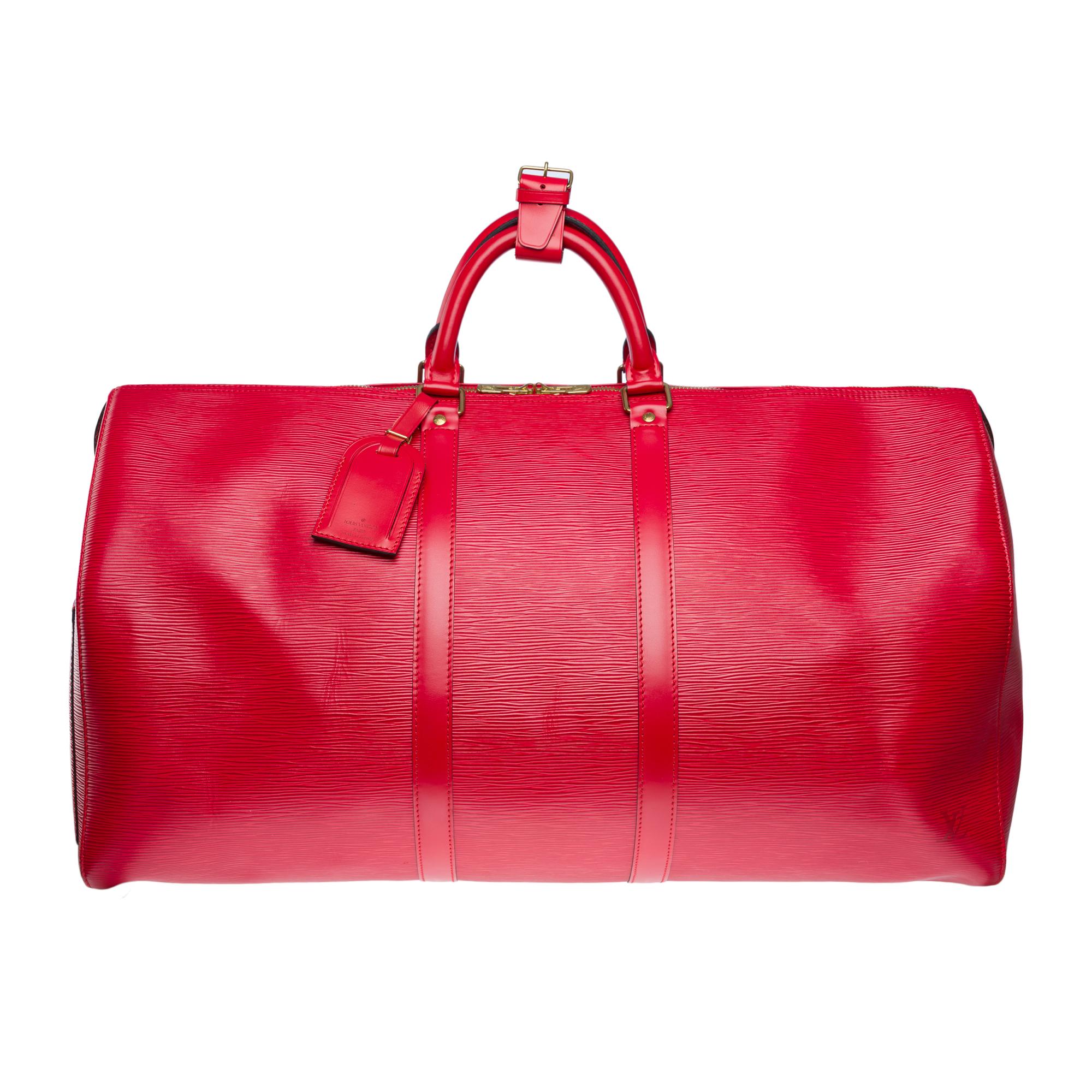 The​ ​very​ ​chic​ ​Louis​ ​Vuitton​ ​Keepall​ ​55​ ​cm​ ​red​ ​epigebre​ ​leather​ ​travel​ ​bag,​ ​gold​ ​metal​ ​trim,​ ​double​ ​handle​ ​in​ ​red​ ​leather​ ​allowing​ ​a​ ​hand​ ​carry

Double​ ​zipper
Red​ ​suede​ ​lining
Signature:​ ​