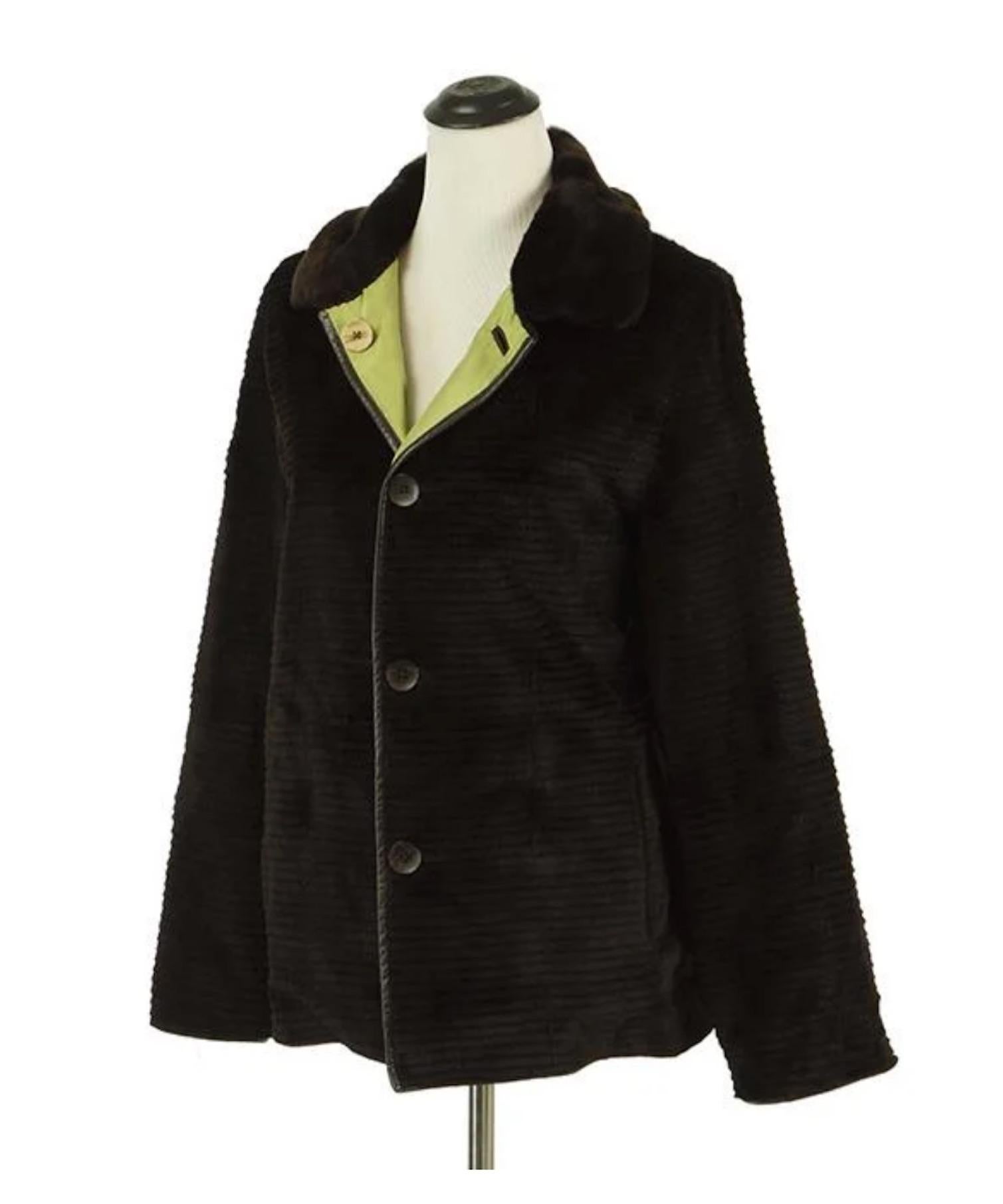 A TRILOGY JACKET.

Reversible green nylon and black leather jacket with a rabbit fur collar reverses to tiered sheared rabbit with jacket with slash pockets

Approximately a size 12