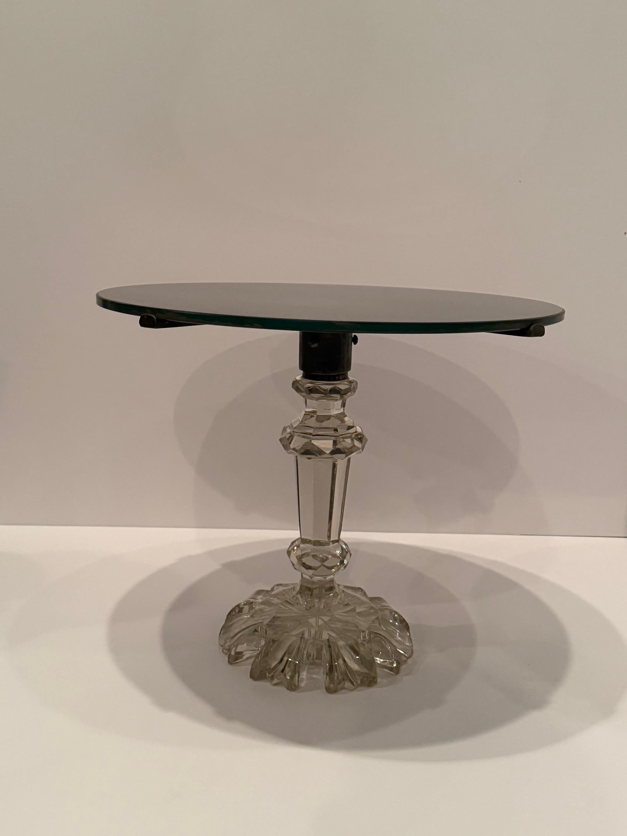 Very elegant round small side table having gorgeous cut crystal base.  The top has been retrofitted with a tinted glass top.