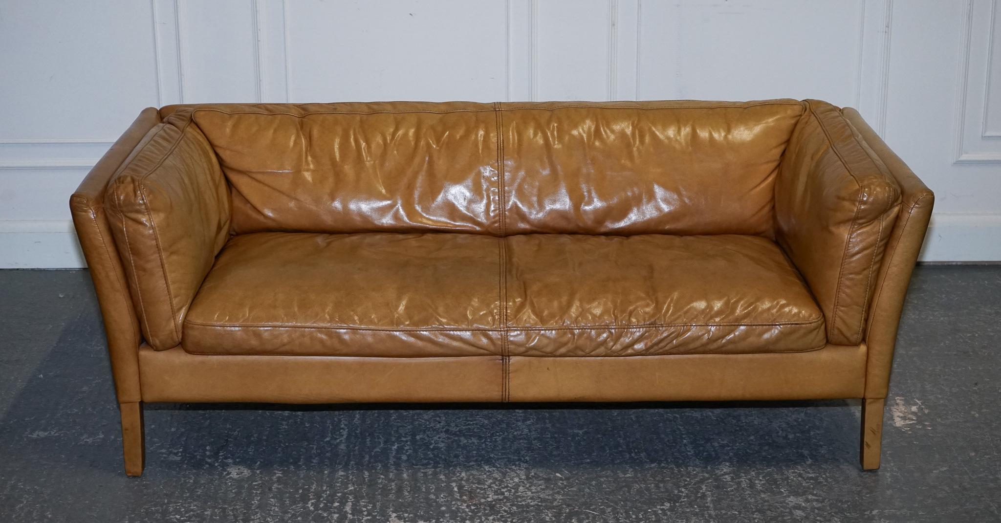 
We are delighted to offer for sale this Very Comfortable Leather Groucho Tan Leather Sofa.

A very well made and solid and compact sofa, it is perfect for small spaces or if you simply want something nice and compact in your toom. In a good