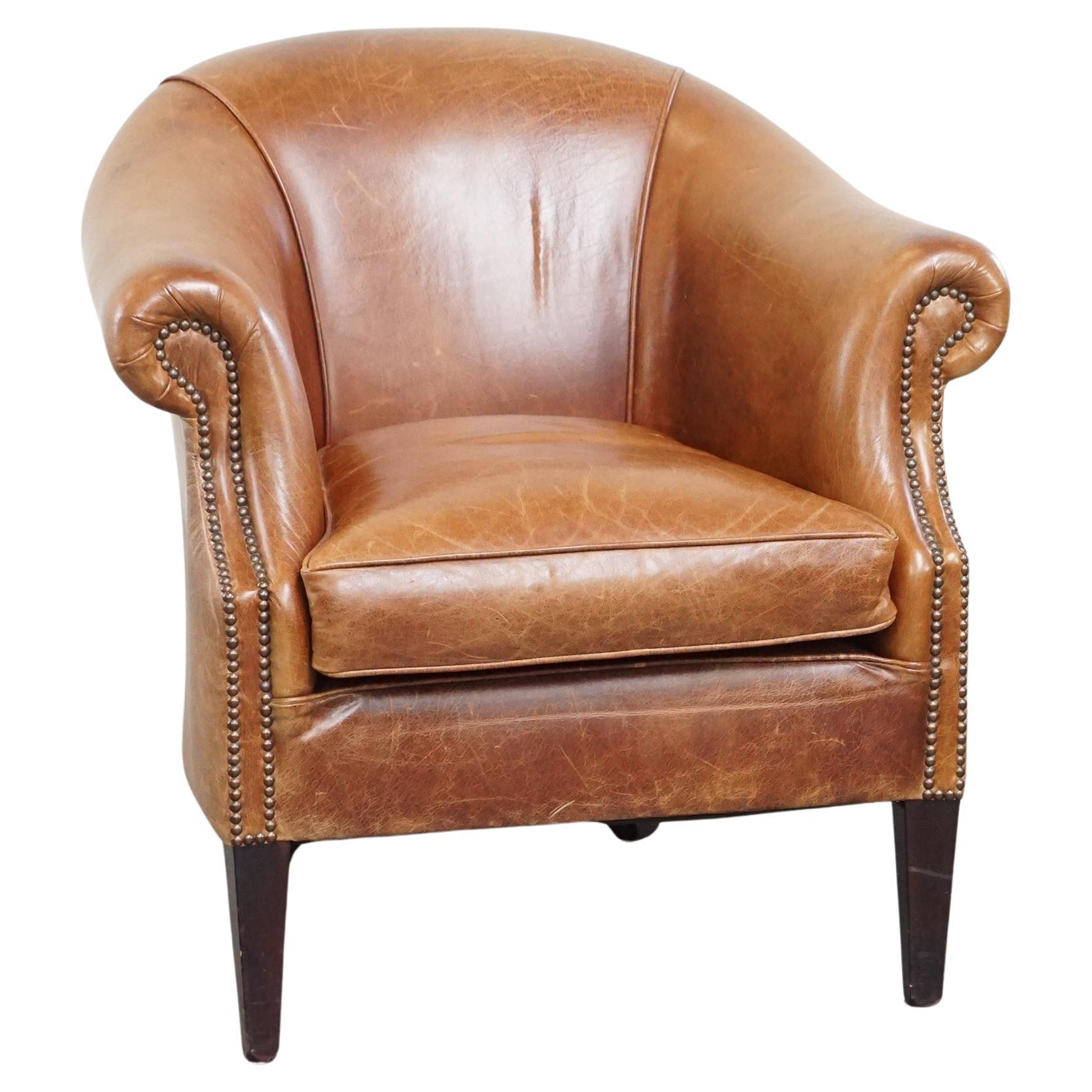 Very comfortable, elegant leather club armchair with a removable seat cushion