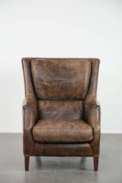 Very comfortable vintage cow leather armchair with character