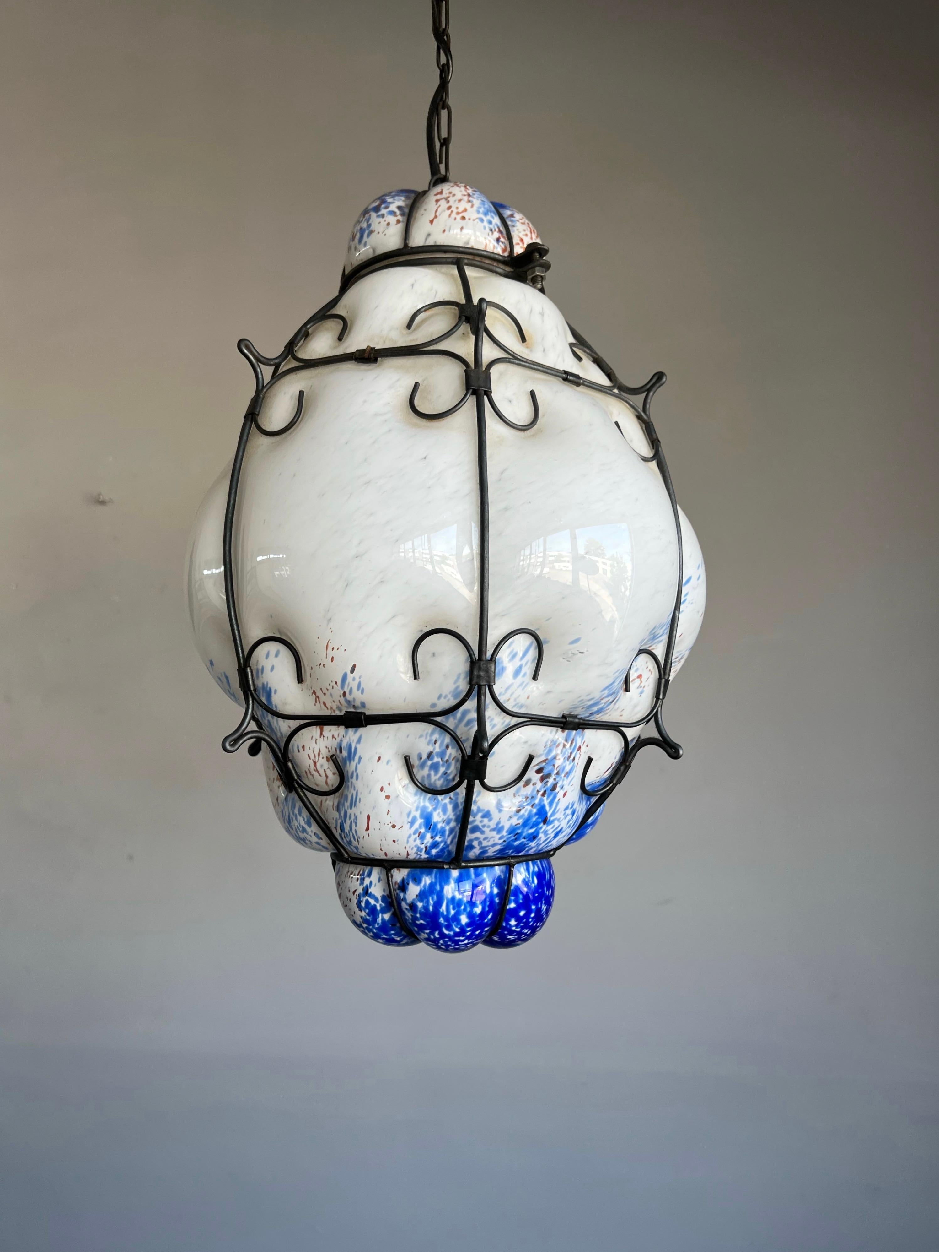 Remarkable white Murano light fixture with earthen red and ocean blue inclusions.

One of the reasons why we think we have the best job in the world is that we keep finding beautiful and all handcrafted antiques that we have never seen before. We