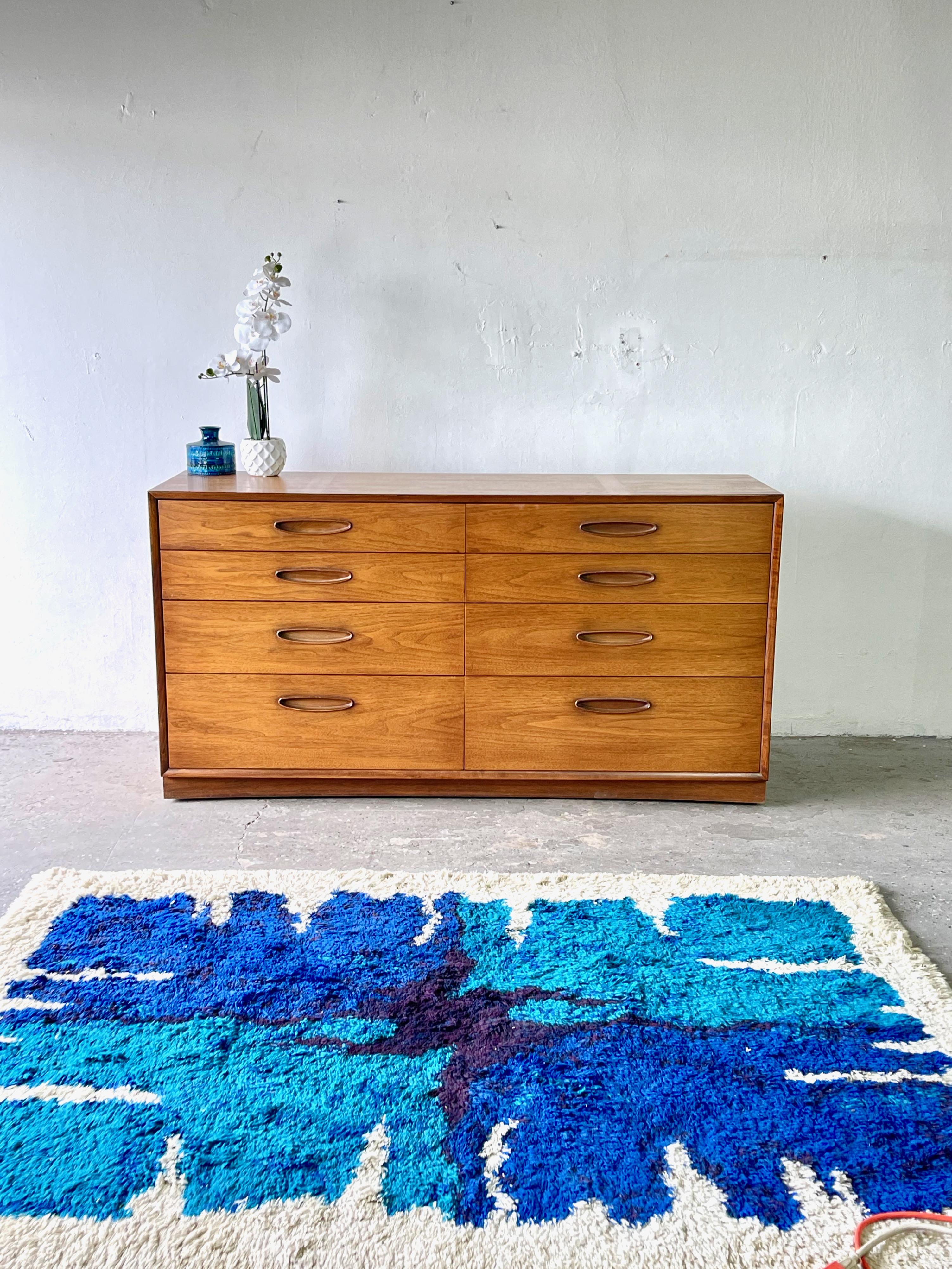 The Dresser is done in solid wood with walnut veneer with Danish Style recessed drawer pulls. Plenty of storage packed into this piece with extra deep lower drawers, removable drawer dividers. Build on casters for easy room placement. The overall