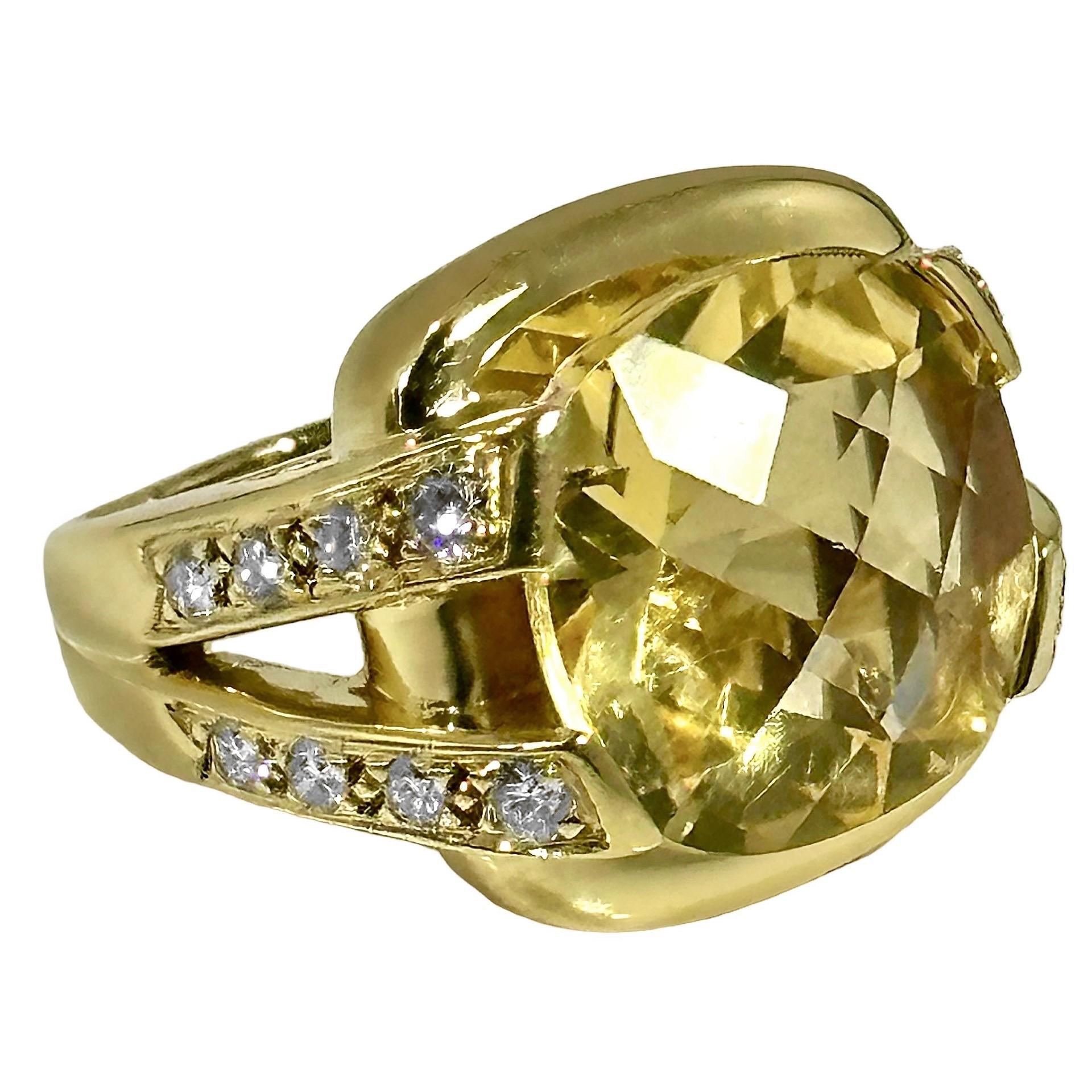 This intriguing Late-20th Century 18k yellow gold fashion ring features a cushion shaped and checkerboard cut golden citrine flanked by two 