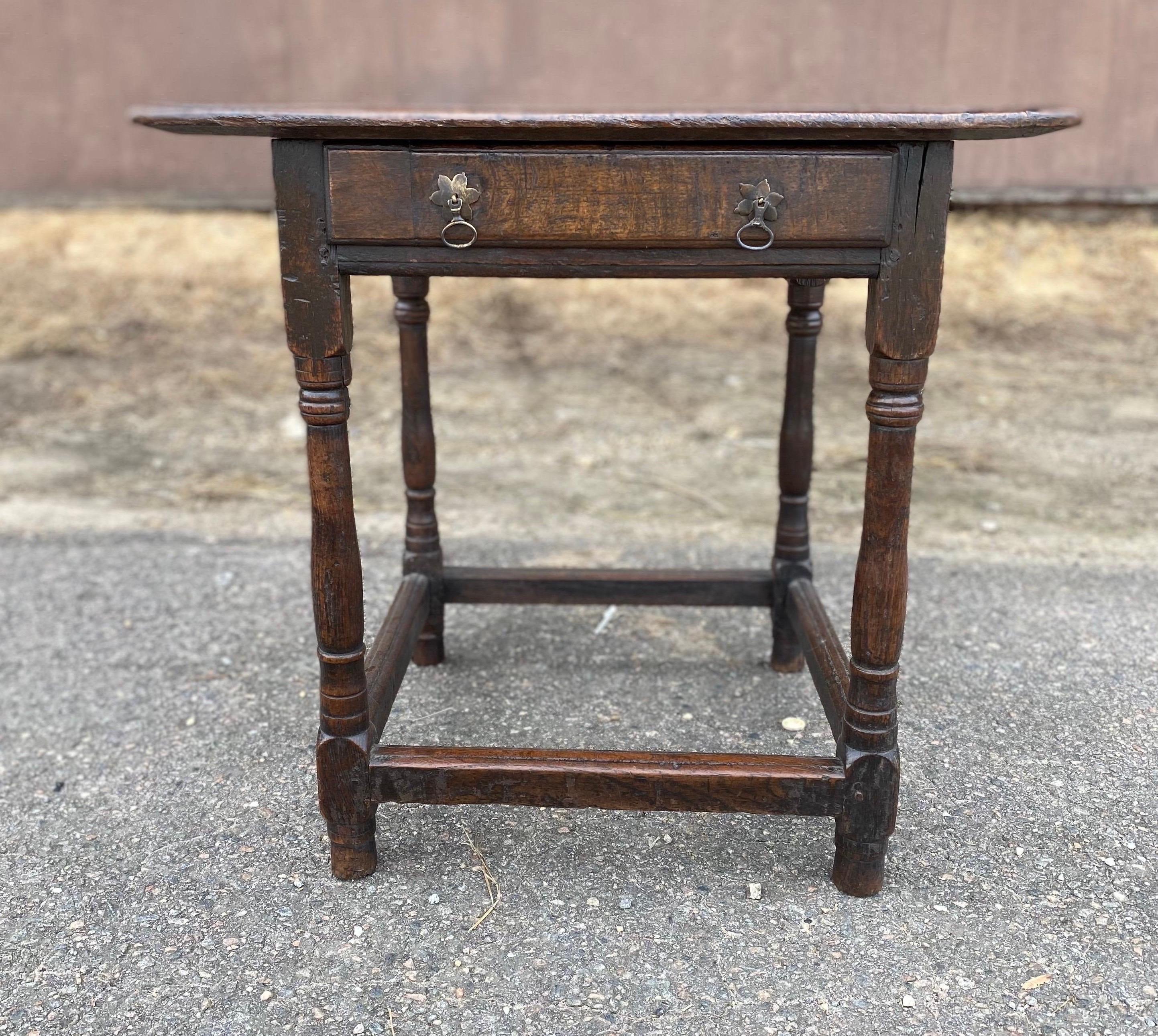 Very early 18th century English oak joint table with drawer. Incredible patina and color. Box stretcher. Wonderful height as a side table or end table.