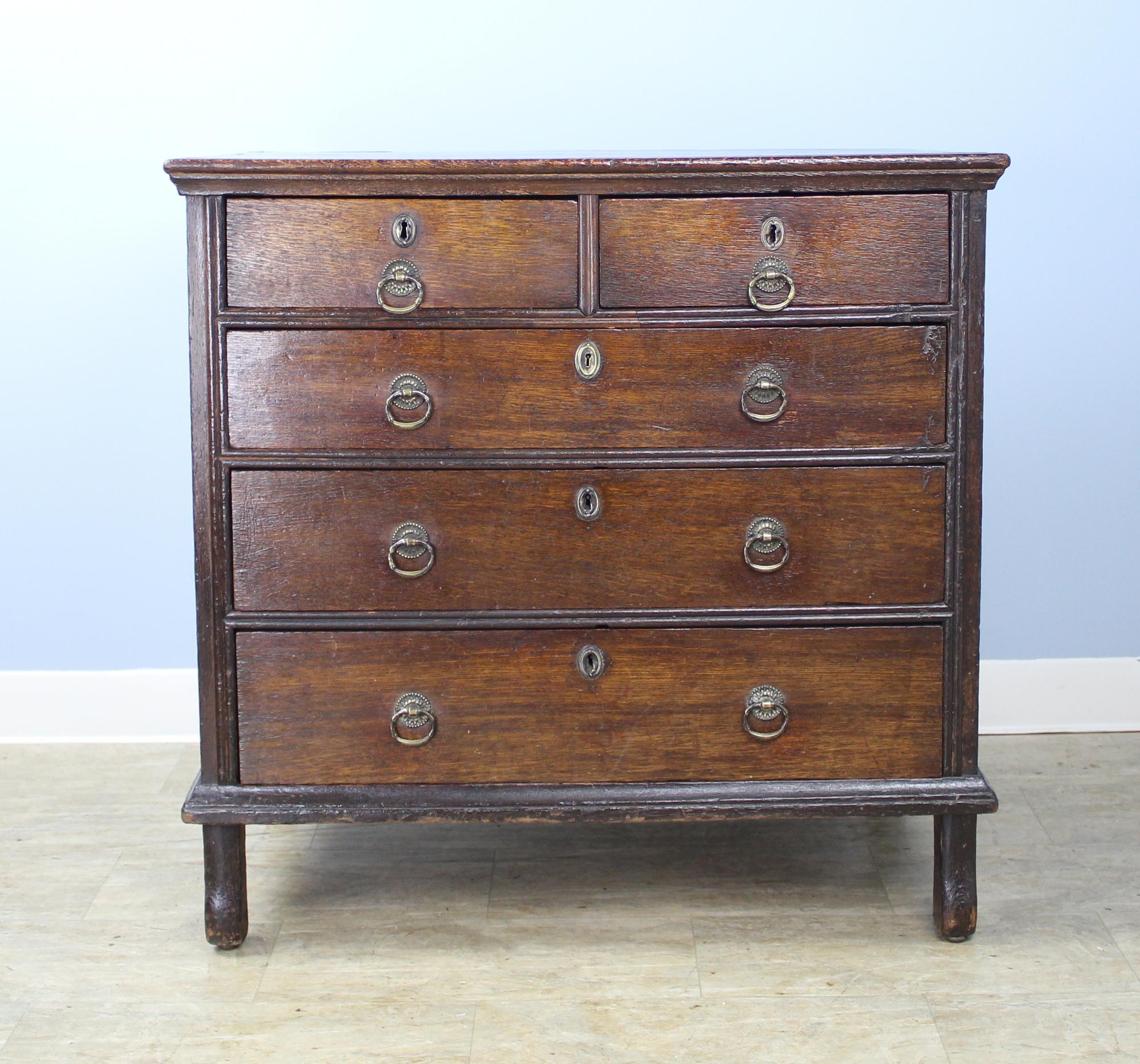 An exquisite chest of drawers, English, circa 1700. The stile feet are original to the piece, as are the drawer pulls and keyholes. The oak is finely grained and patinated, with good top molding, and the interior of the piece is clean and in all