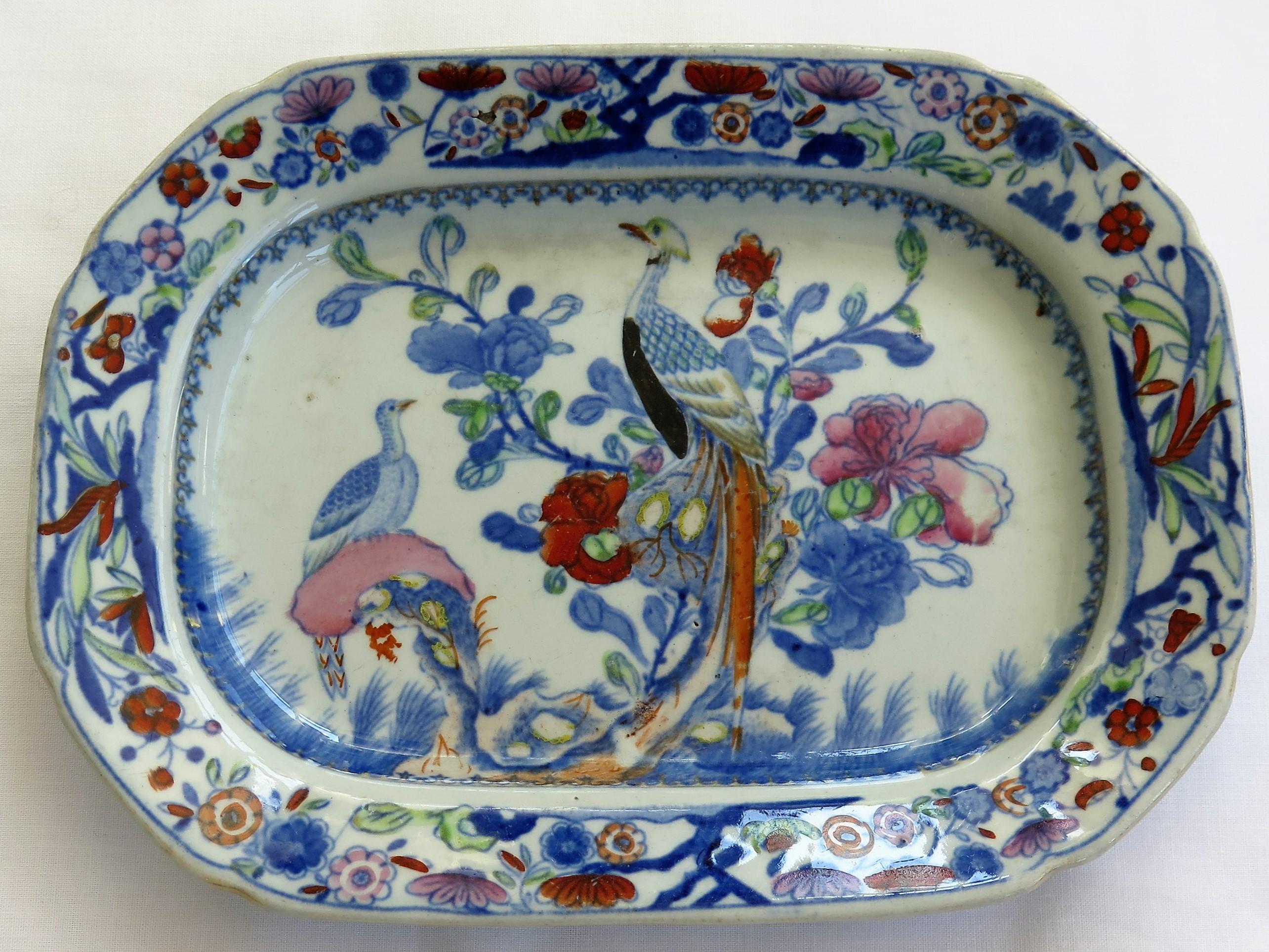 This is a very decorative dish or small tray by Mason's Ironstone, Lane Delph, England in the Oriental Pheasant pattern, dating to the very earliest transitional period of Mason's ironstone, circa 1812.

The dish is rectangular in shape with a