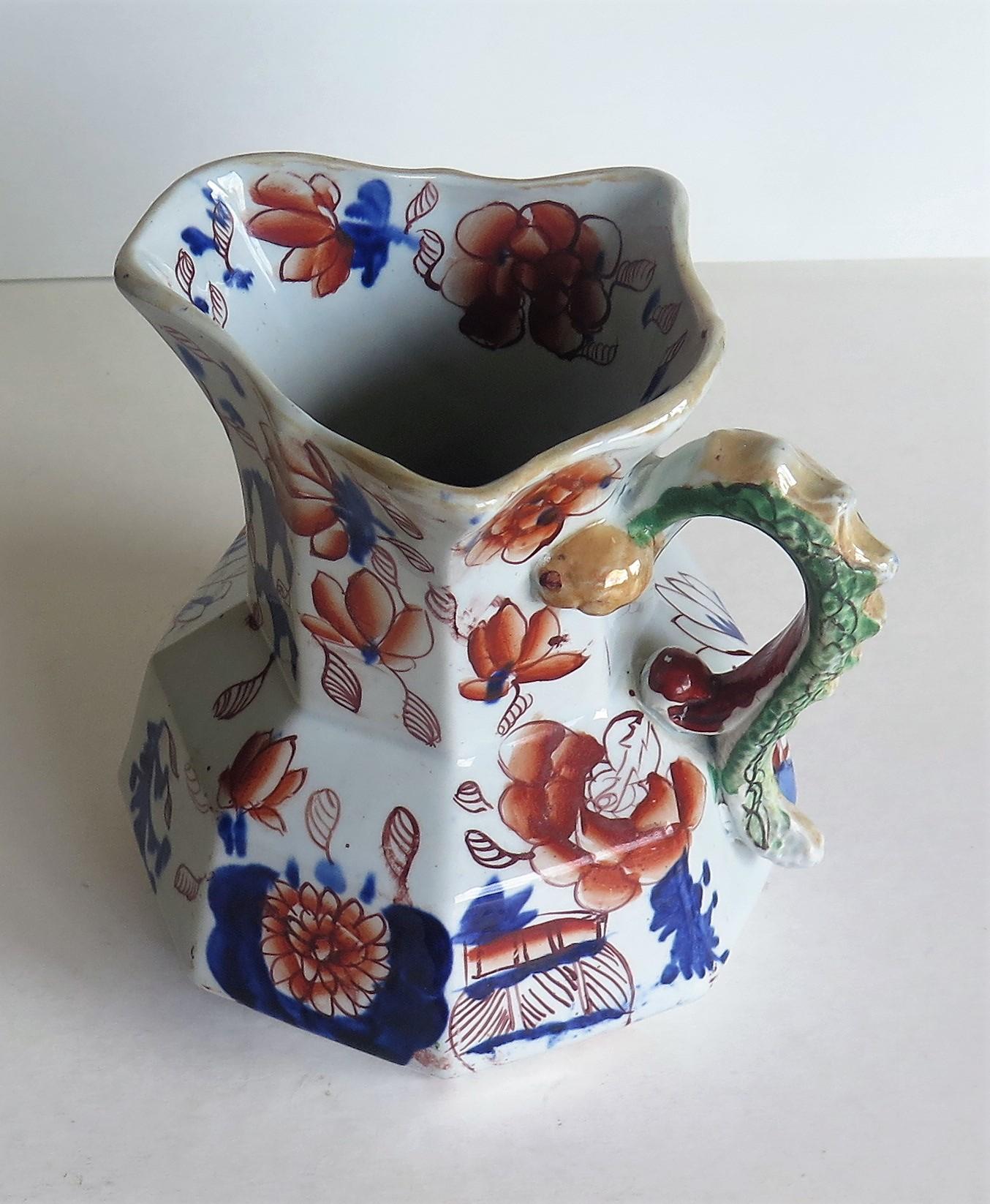 This is a good, very early Mason's Ironstone Hydra jug in the Japan basket pattern, circa 1813-1815, which is the late George 111rd period. 

The jug has an octagonal shape with a notched snake handle and is hand decorated in the distinctive Japan