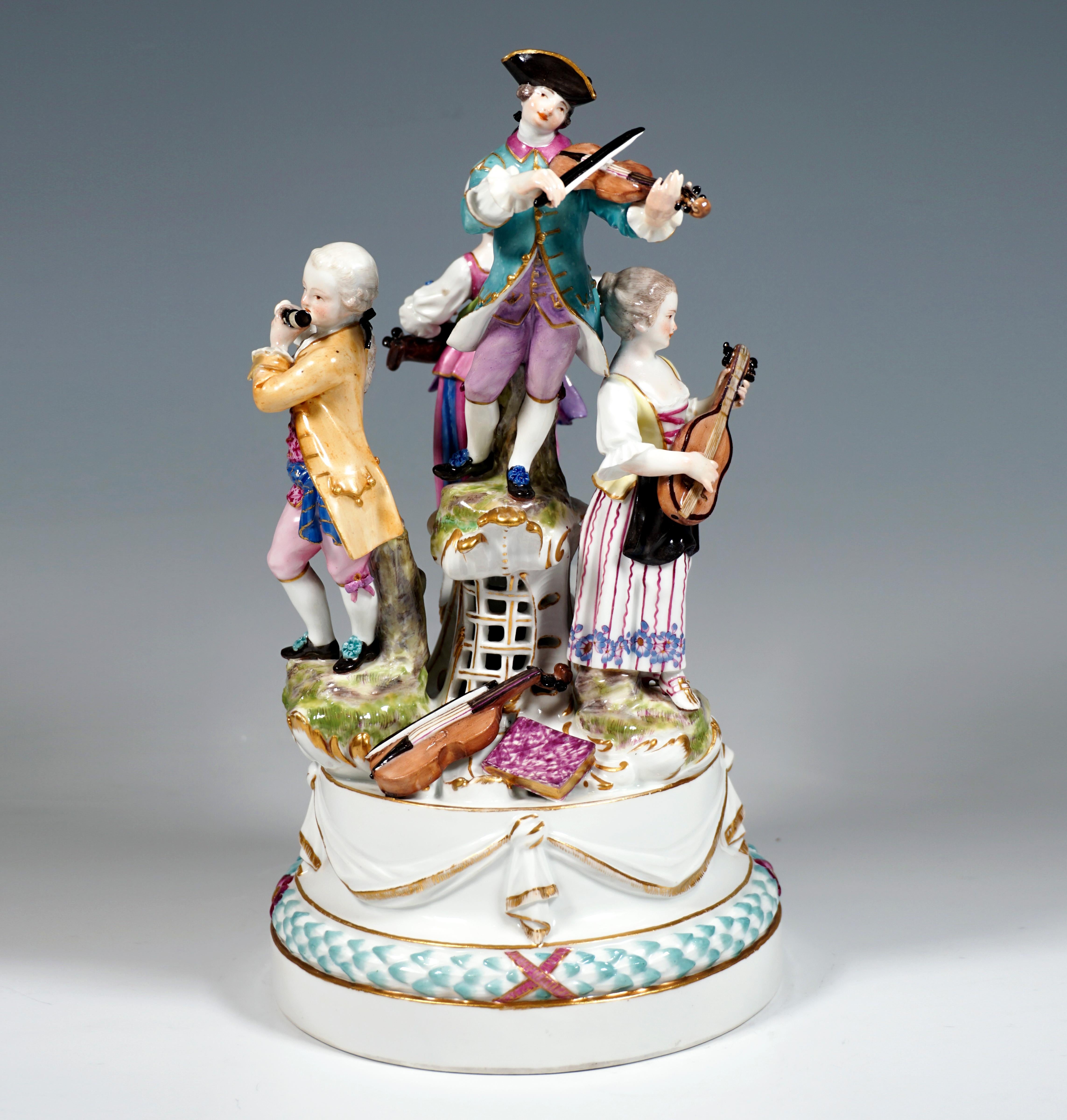 Elaborately crafted porcelain group from the 18th century:
Four musicians in festive, rural Rococo clothing on a high round base, adorned with a three-dimensional wreath of leaves and festively knotted white cloth with gold decoration. On the base