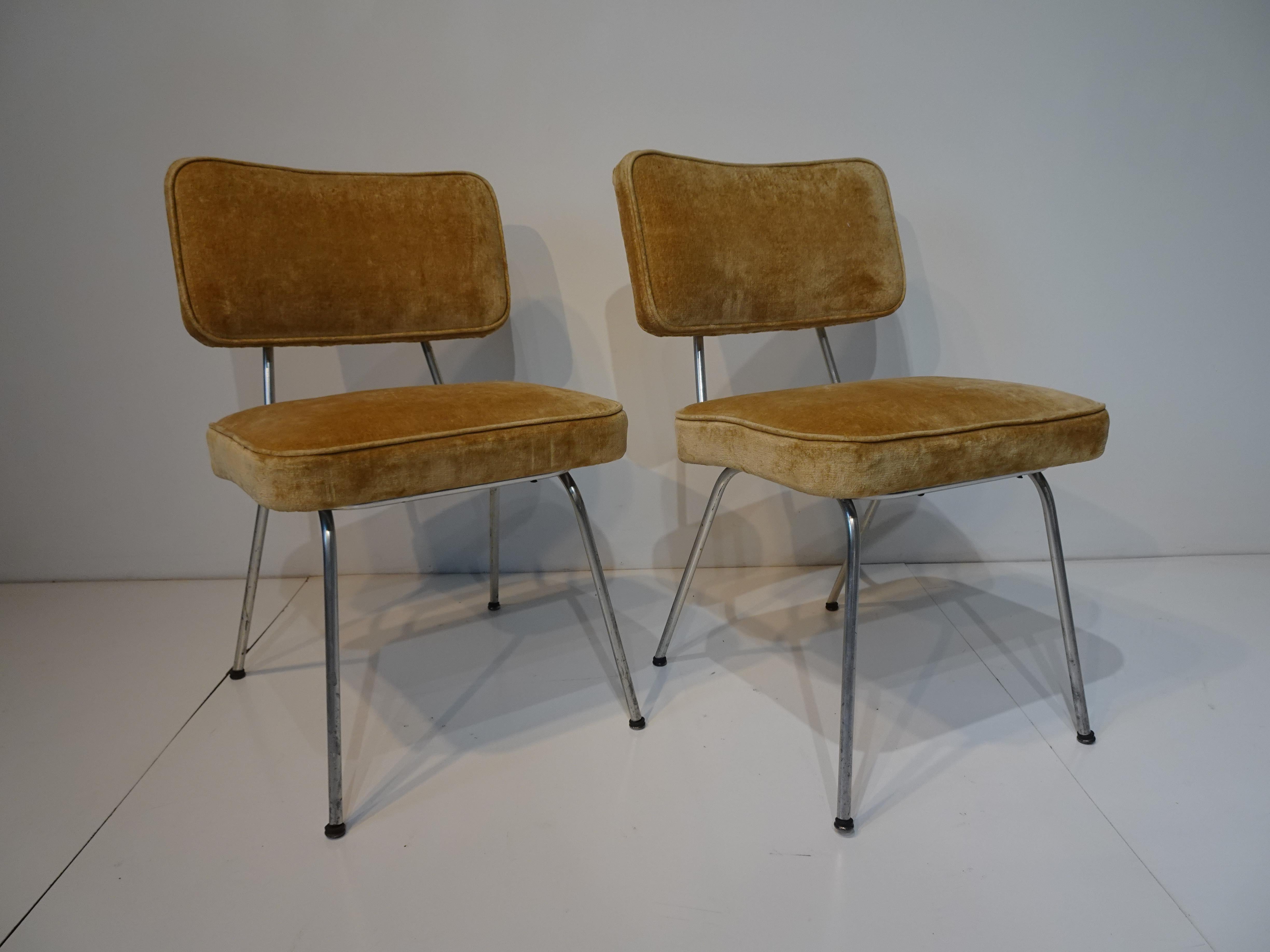 A pair of rare and early production upholstered George Nelson chairs with sculptural satin aluminum tube frames and screw in foot pads . Manufactured by the Herman Miller Furniture company as pictured in their 1955 factory catalog as model number