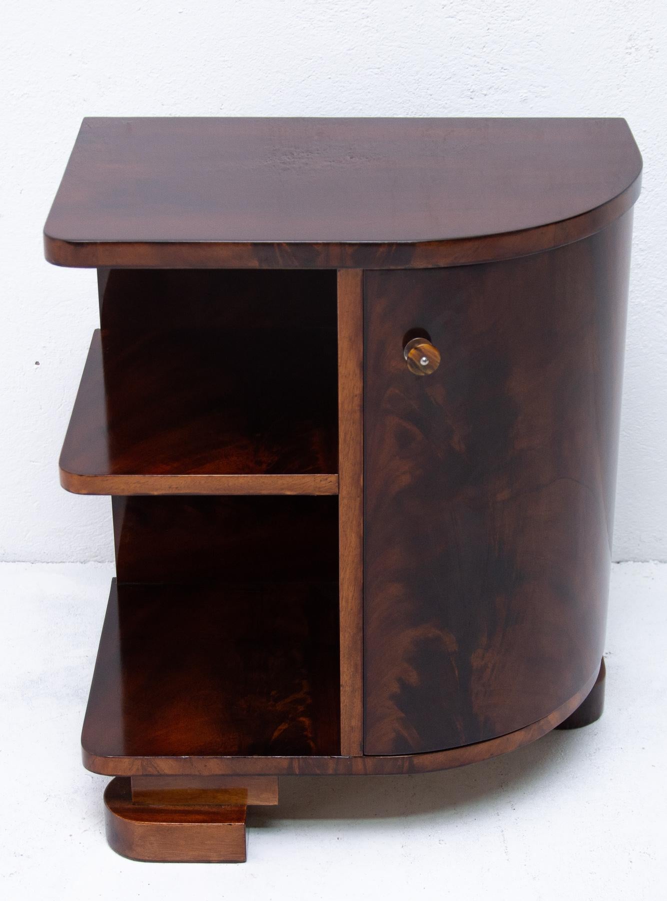 This walnut Art Deco dry bar was made in the 1930s in Bohemia. The cabinet has very interesting shapes and is a wonderful example of the typical Art Deco style. It was completely refurbished and polished to a high gloss.
It features a storage space