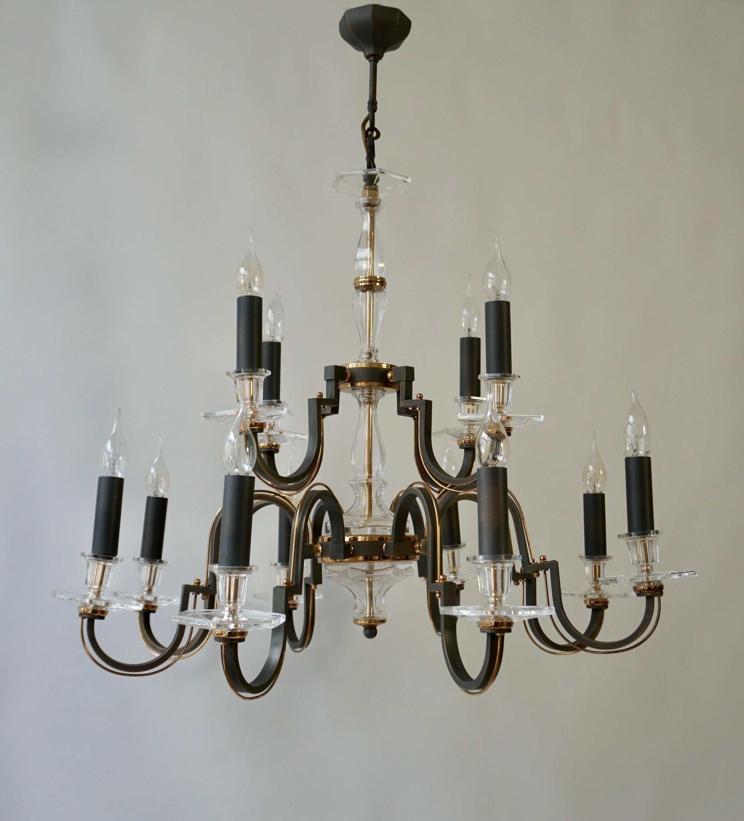 A large Hollywood Regency twelve-armed chandelier from France manufactured in the mid-century (1970s and 1980s). The chandelier has twelve sockets for small incandescent lamps with screw base or E14 type LEDs. It is possible to install this fixture