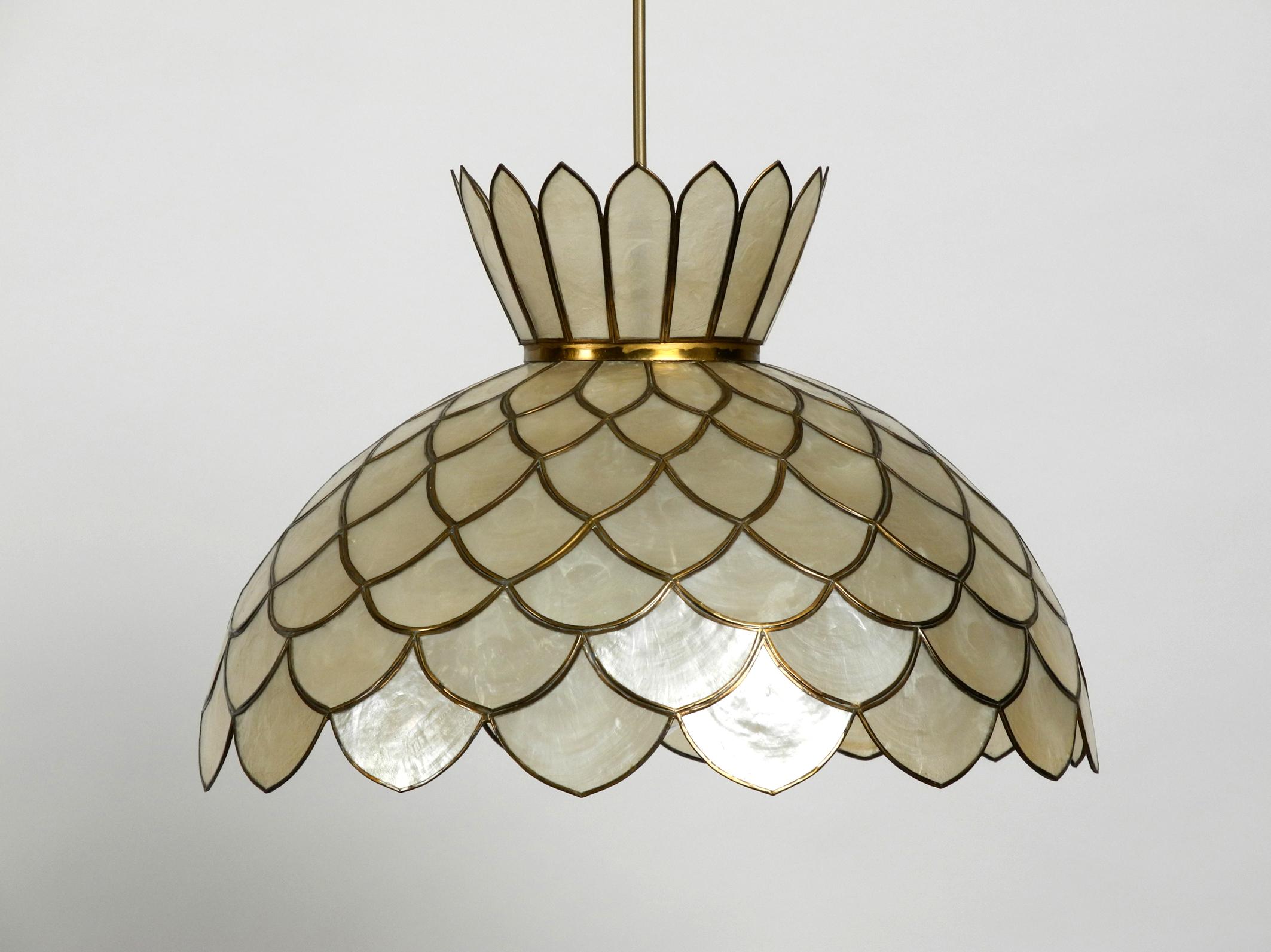 Very elegant flowers pendant lamp made of mother of pearl. 
Great rare design from the 1970s. Very high quality workmanship. 
Pleasant light with the original E27 socket. No damage to the entire lamp. 
All leaves firm and complete. Just one