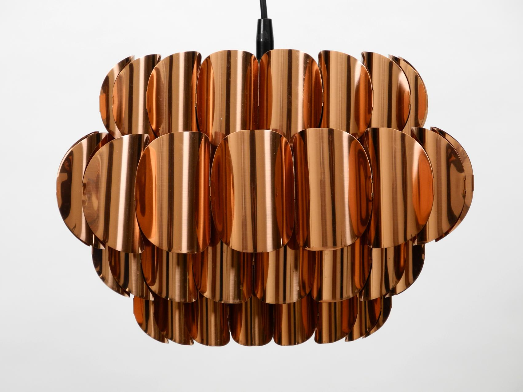 Very rare extraordinary large 1970s original lamella pendant lamp made of copper.
Made in Switzerland. High quality and elegant design.
Lampshade consists of 4 individual rings of copper with different diameters.
One E27 socket. Rewired due to