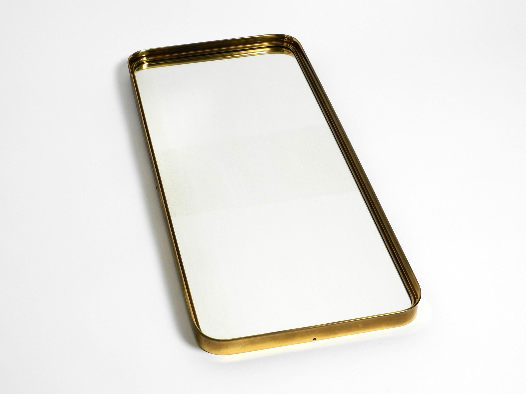 Mid-Century Modern Very Elegant Minimalist Mid Century Brass Wall Mirror by Vereinigte Werkstätten For Sale