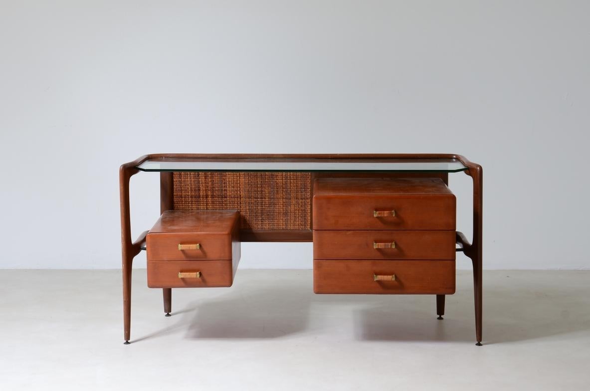 COD-2483
Very elegant curved wooden console with double row of light wood drawers with handles covered in straw and woven straw backrest, thick tempered glass top.

1960's manufacturing.

130x45xh65