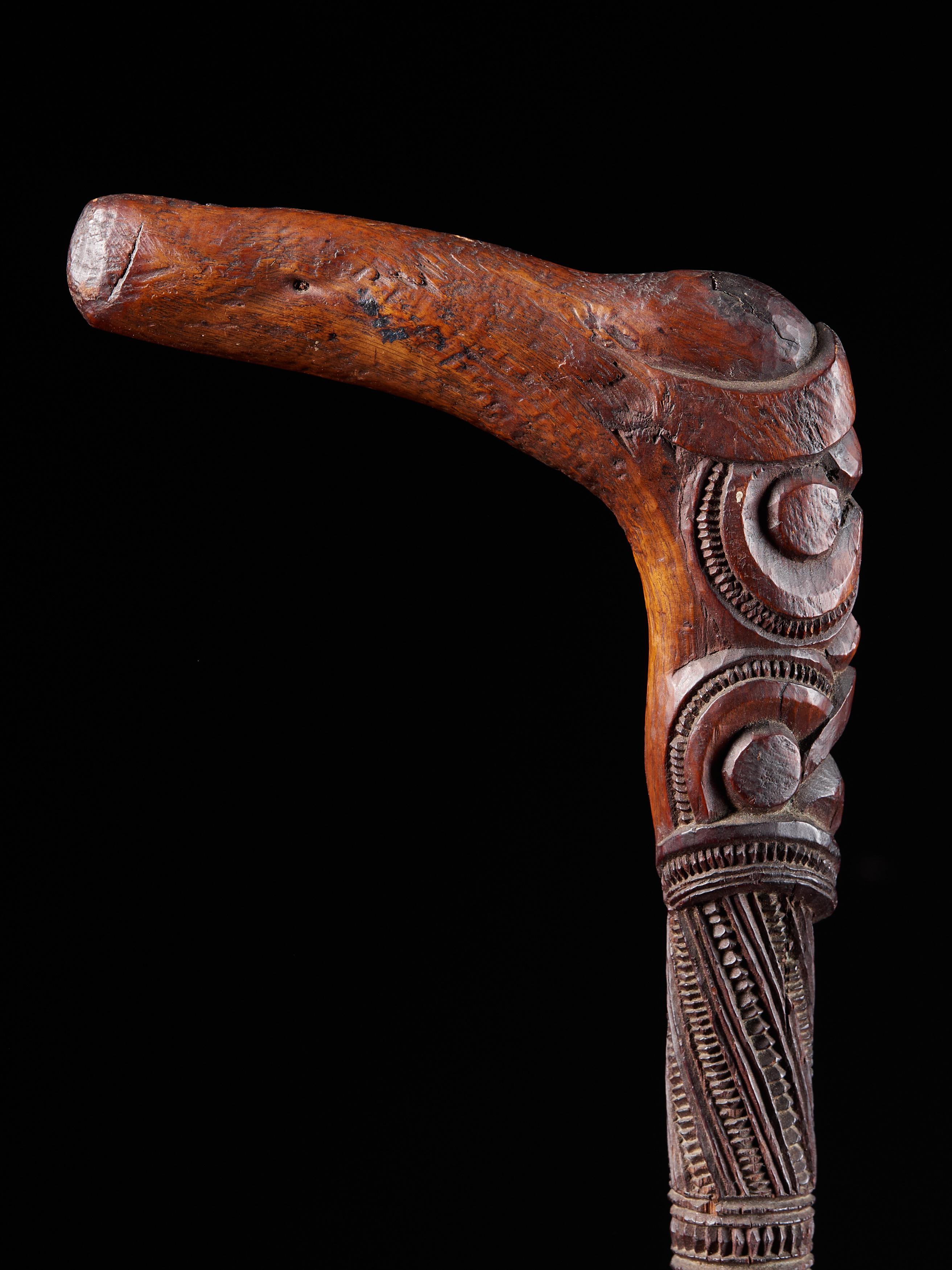 A completely carved, polished Maori wooden stick with crook in one piece. This walking stick or orator's staff is known as a tokotoko. Symbol of authority, this item was usually held during formal speeches.