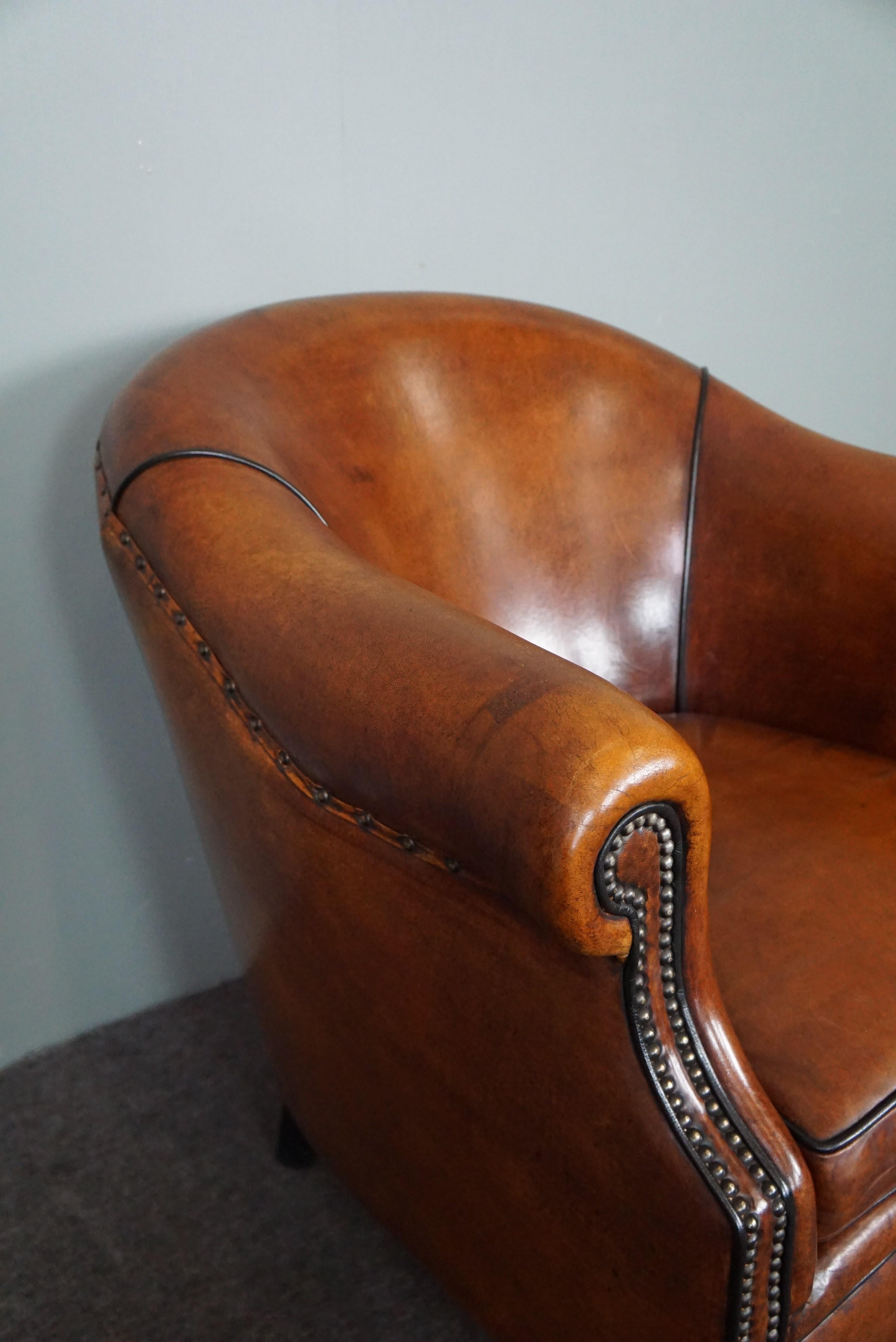 Leather Very expressive sheep leather club chair with black piping For Sale