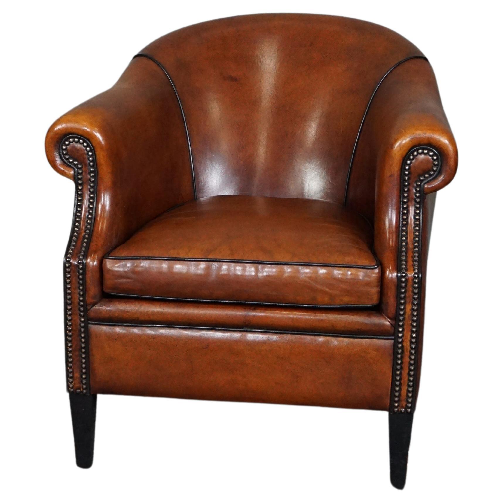 Very expressive sheep leather club chair with black piping For Sale
