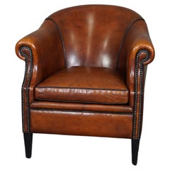 Very expressive sheep leather club chair with black piping