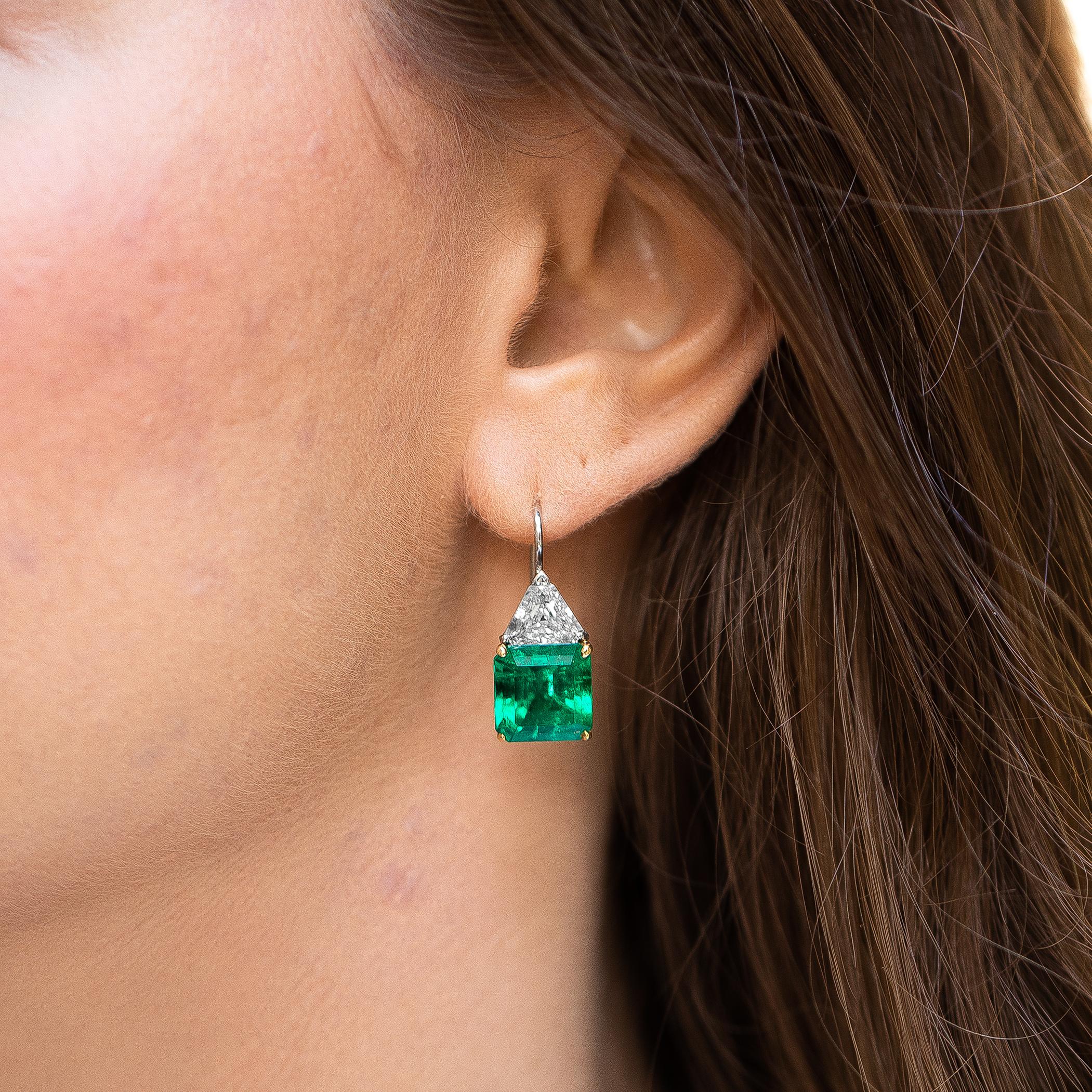 Stunning Asscher Emeralds and Trillion cut diamonds make these earrings the perfect balance of class and luxury. 
Very Fine AGL Certified Emeralds = 5.75 Carat + 5.53 Carat
2 Diamonds = 3 Carats
( Color: E, Clarity: VS )
Metal: Platinum & 18K Yellow