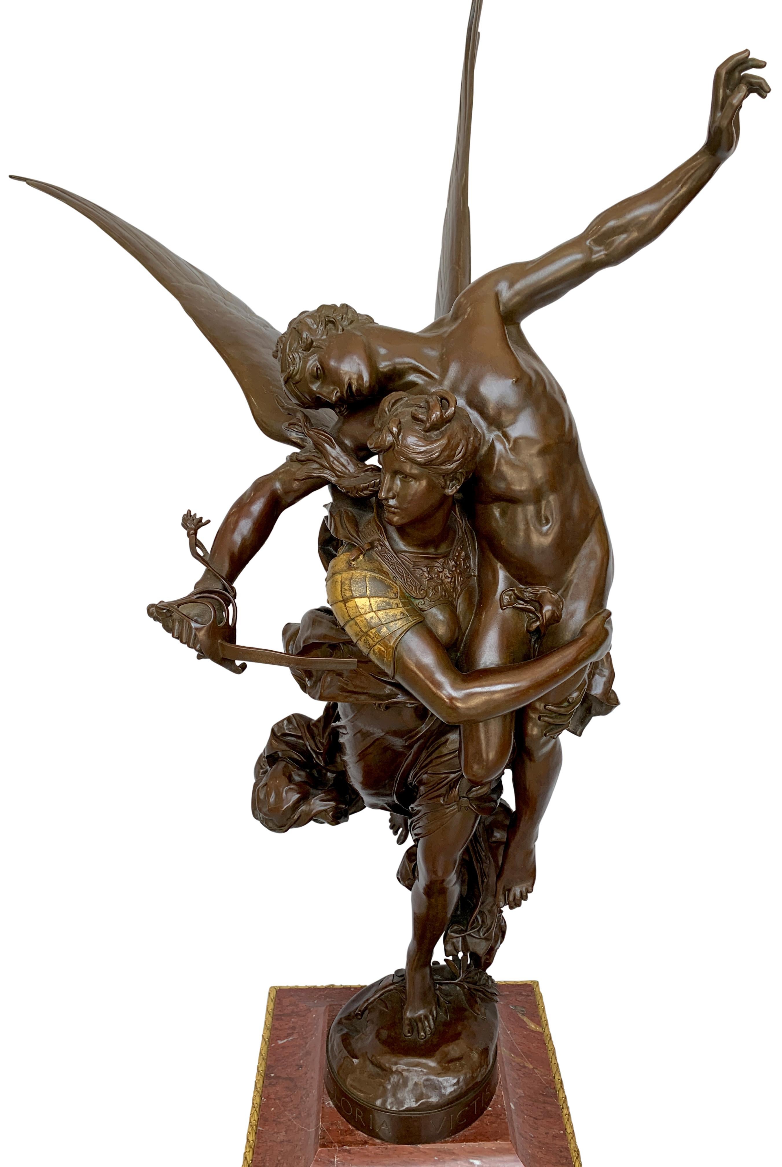 A magnificent French patinated bronze figural group entitled 'Gloria Victis' by Marius-Jean-Antonin Mercie, raised on ormolu mounted rouge marble clock base. Original rich dark patina.
Mercié's original plaster sculpture of Gloria Victis won a medal