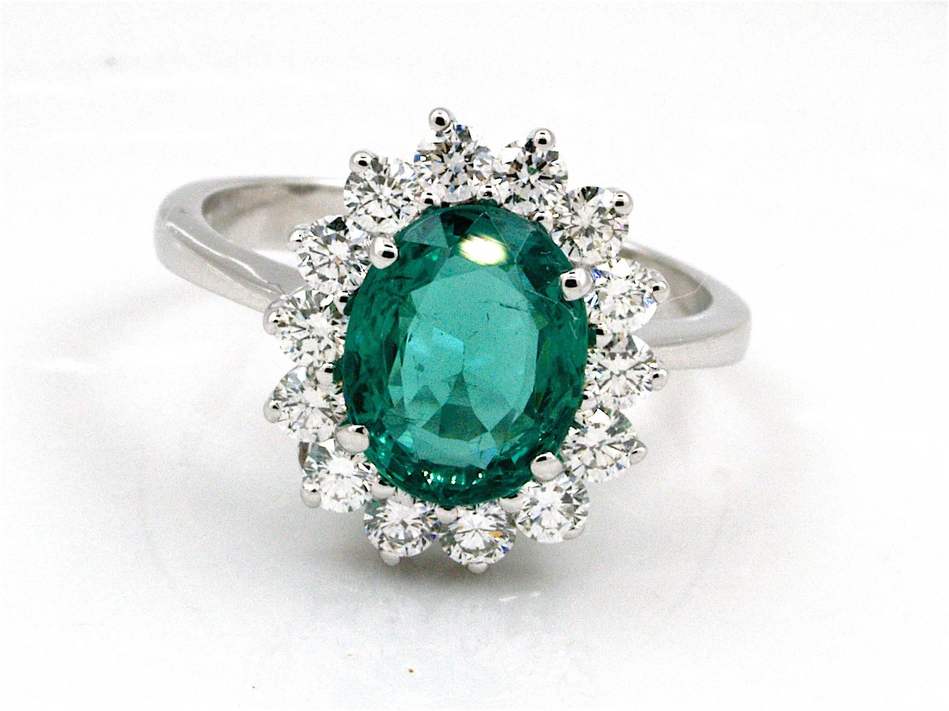 This gorgeous ring is centered with 1 genuine Oval cut emerald weighting 2 ct, prong set,  It is flanked by a row air of brilliants cut diamonds weighing 0.75 cts, graded F-G-H color and VVS-VS clarity. This beautifull ring is new.

This emerald is