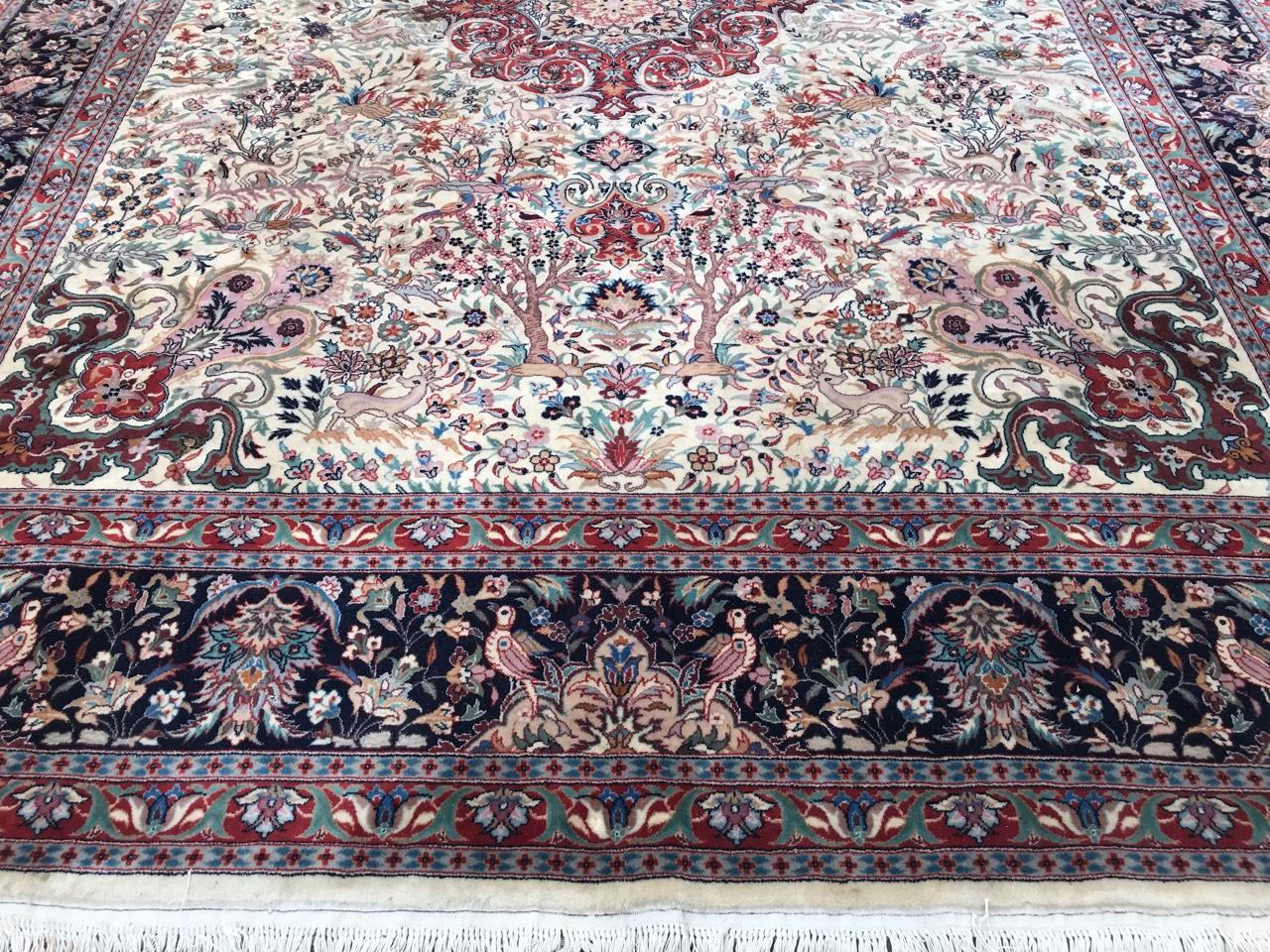 Exquisite large rug featuring a stunning design with a central medallion. Beautifully hand-knotted with wool velvet on a cotton foundation, this rug boasts vibrant colors including red, pink, green, yellow, and blue. The light field showcases a