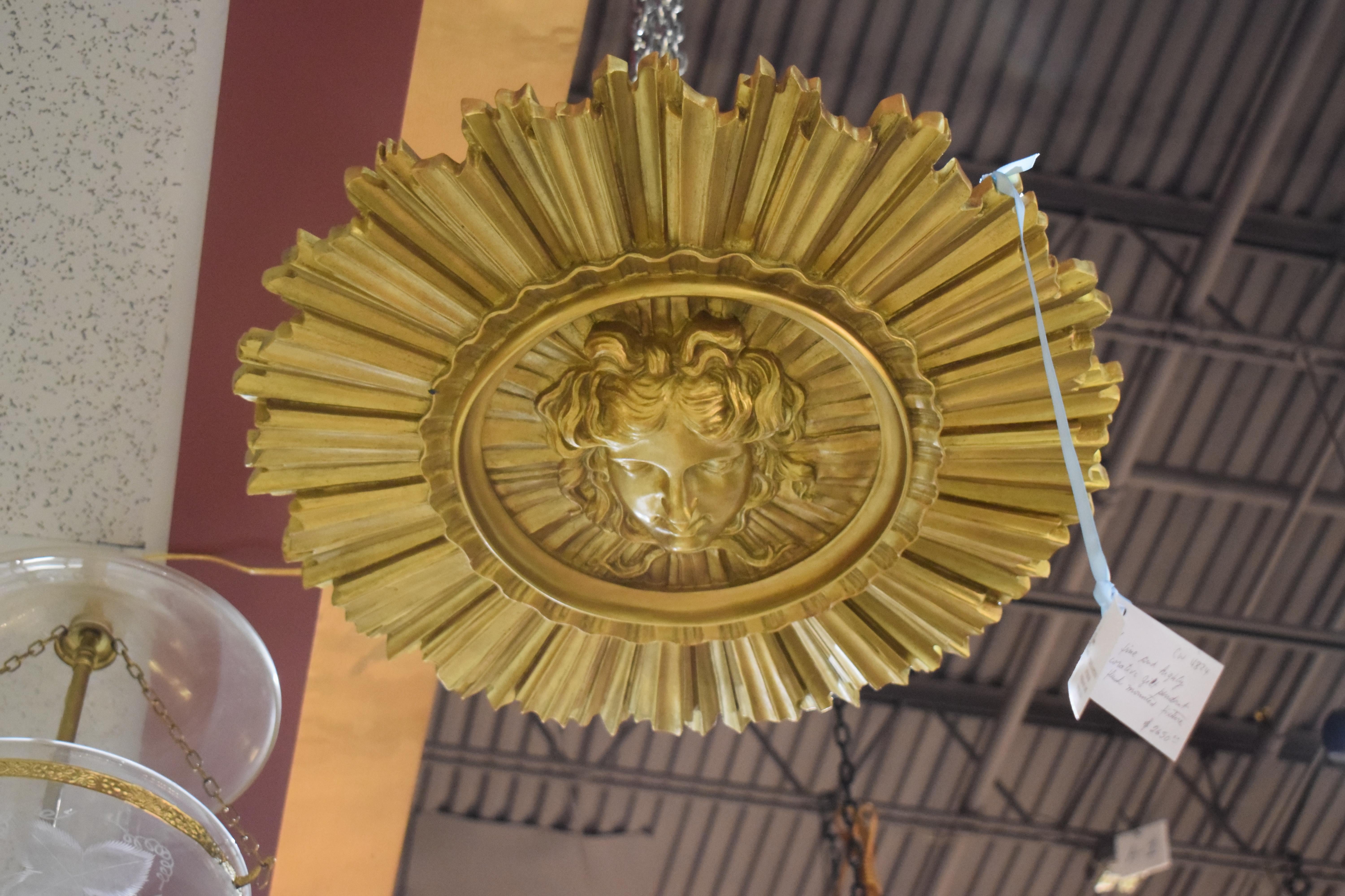 A very fine and highly decorative gilt pendant or flush mounted fixture representing Apollo and Sunburst. Five lights
Dimensions: Height 7