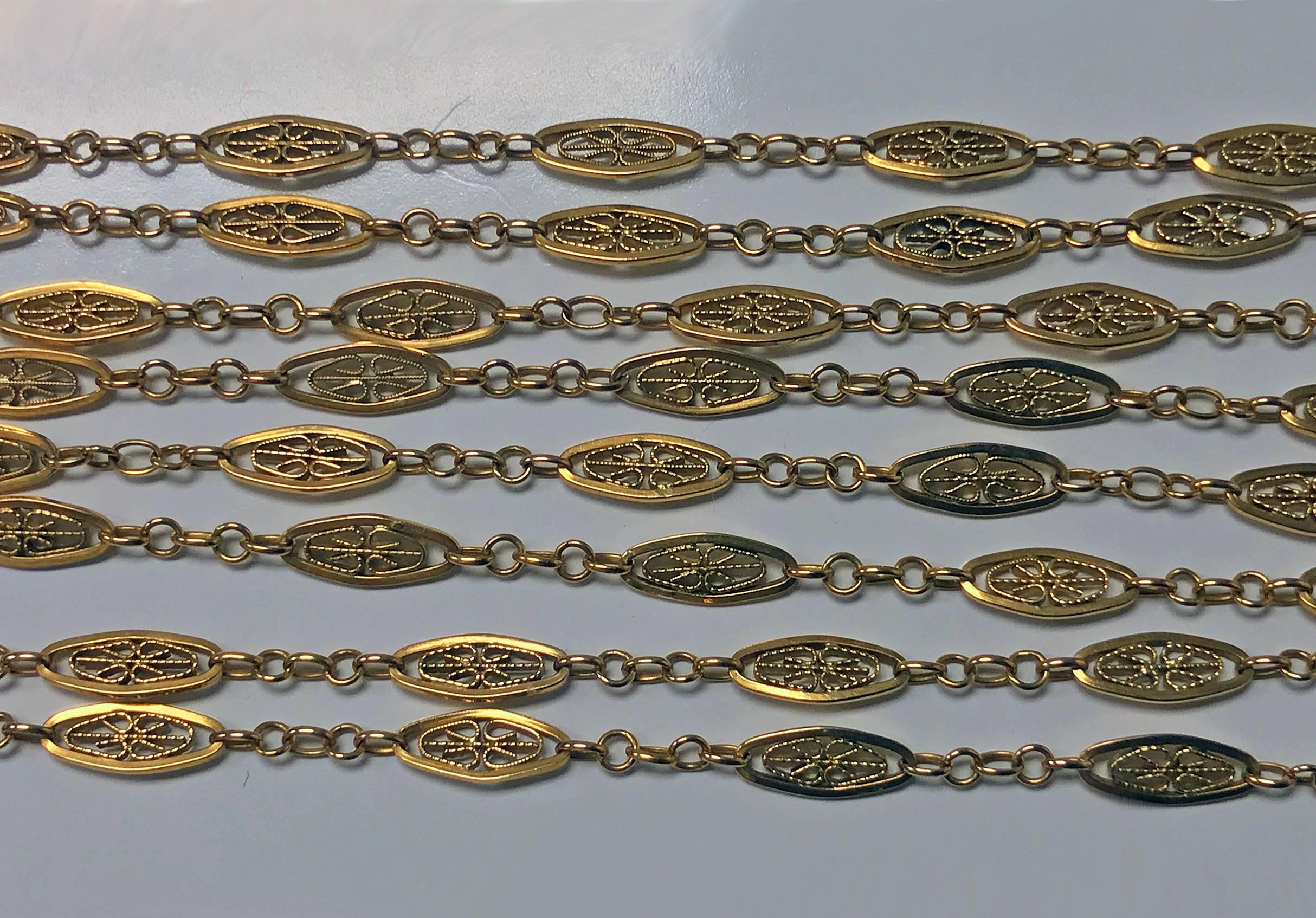 Very fine Antique 19th century 18K rose gold Muff Chain, France C.1890. The chain with lozenge oval granular pierced links terminating with gold spring ring fastener. French eagle mark. Length approximately: 58 inches.  Weight: 29.84 grams.