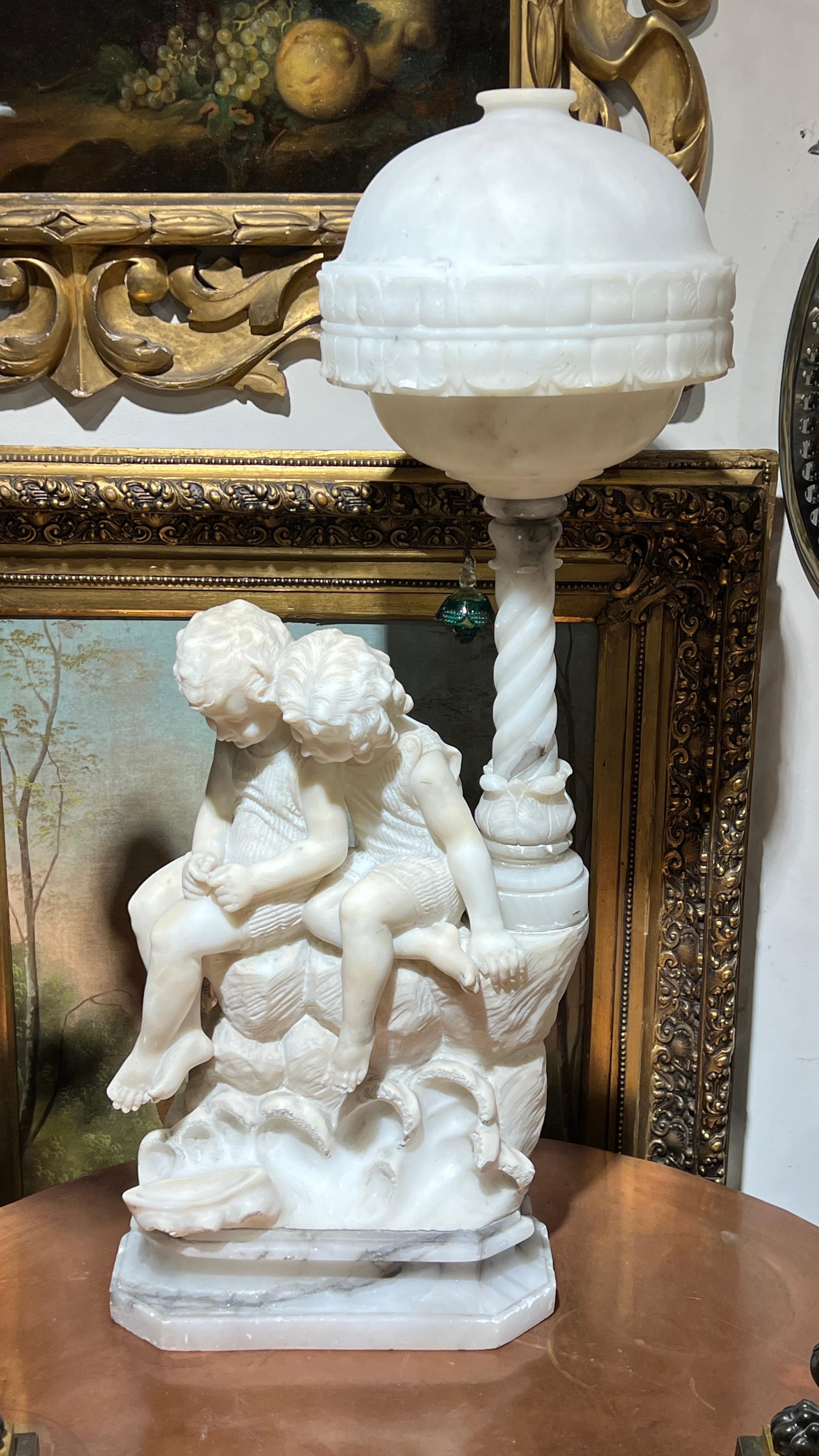 Ravissante lampe en albâtre sculptée à la main représentant un jeune garçon et une jeune fille, signée G Mascagni, attribuée au maître italien Gaspar Mascagni, actif à la fin du XIXe siècle et au début du XXe siècle.
