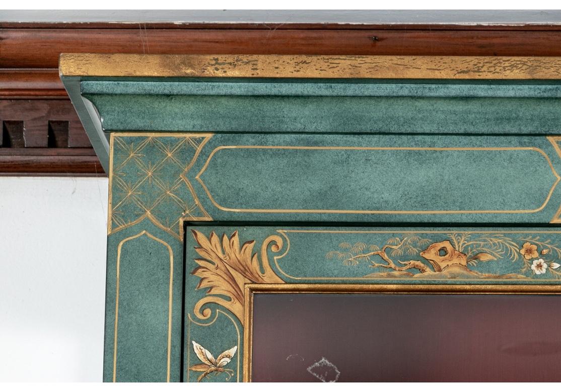 A highly decorated, useful and very well made Vitrine cabinet with three quarter viewing. Having a trim profile and decorated a mottled Green Paint with Gilt Chinoiserie decoration including serene landscapes, pagodas, figures, butterflies, and