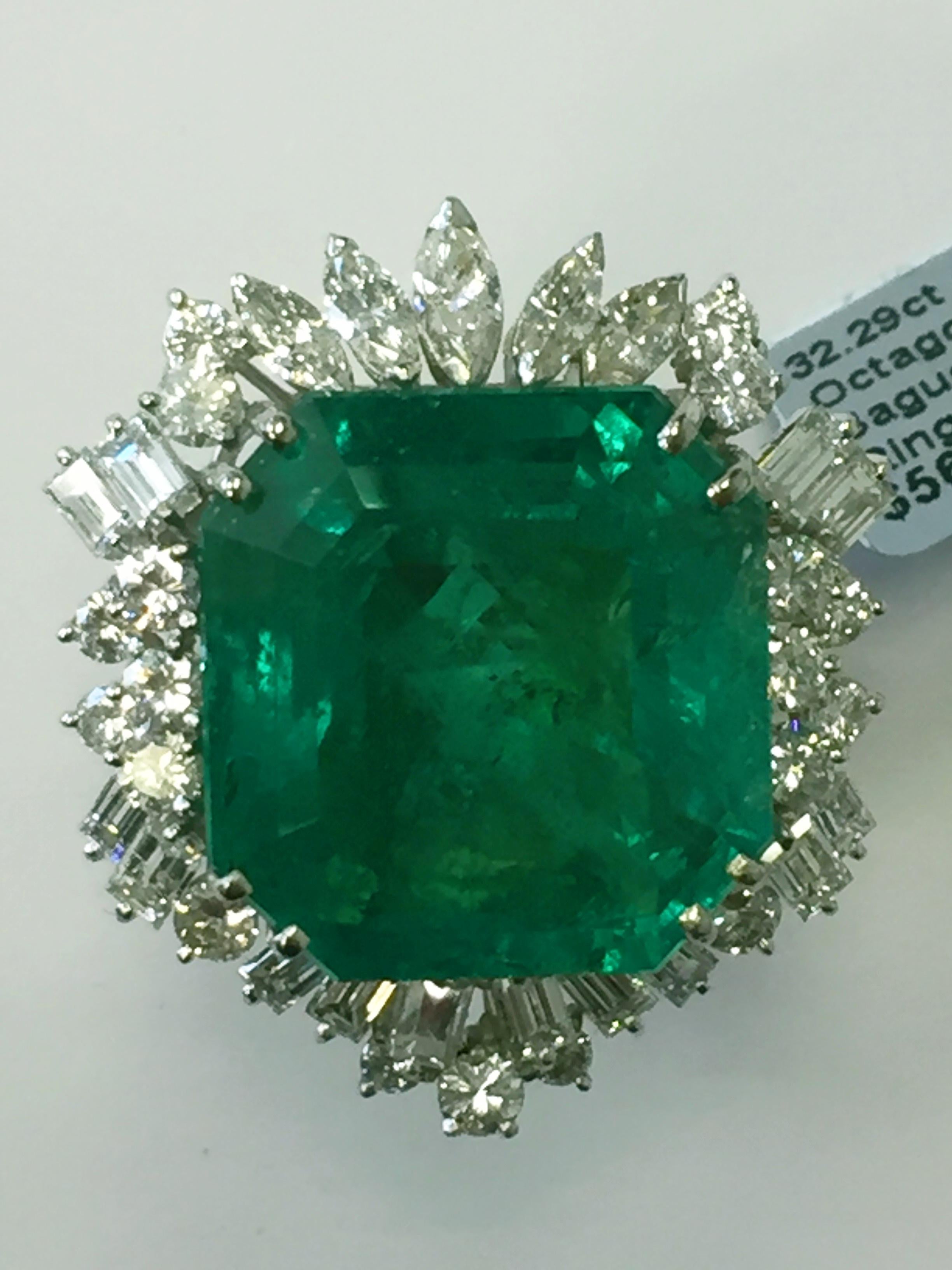 This 32.29 carat Colombian emerald octagon is a beautiful quality with a bright yet rich hue of green.  Surrounded by a unique selection of white diamond baguettes, marquises, and rounds, this ring is eternally graceful! Size 6 with GIA lab report.