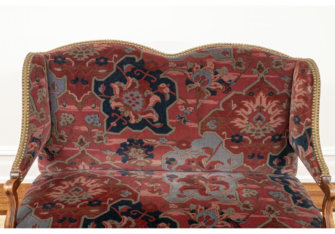 A very well-made and solid feeling Custom Settee in European Style. The Settee features a custom upholstery treatment of complementing woven Oriental Rug type fabric on the seat and back and a handsome Olive Velvet on the sides and back, all with a