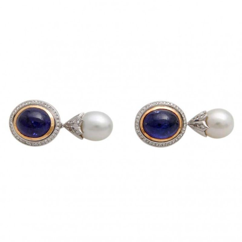 Very fine drop earrings (pair). Especially with 2 tanzanite cabochons, 2 South Sea pearls, hanging and diam. total 0.87 ct.m TW/VSI. WG/RG 18 K. High-quality goldsmith work.
