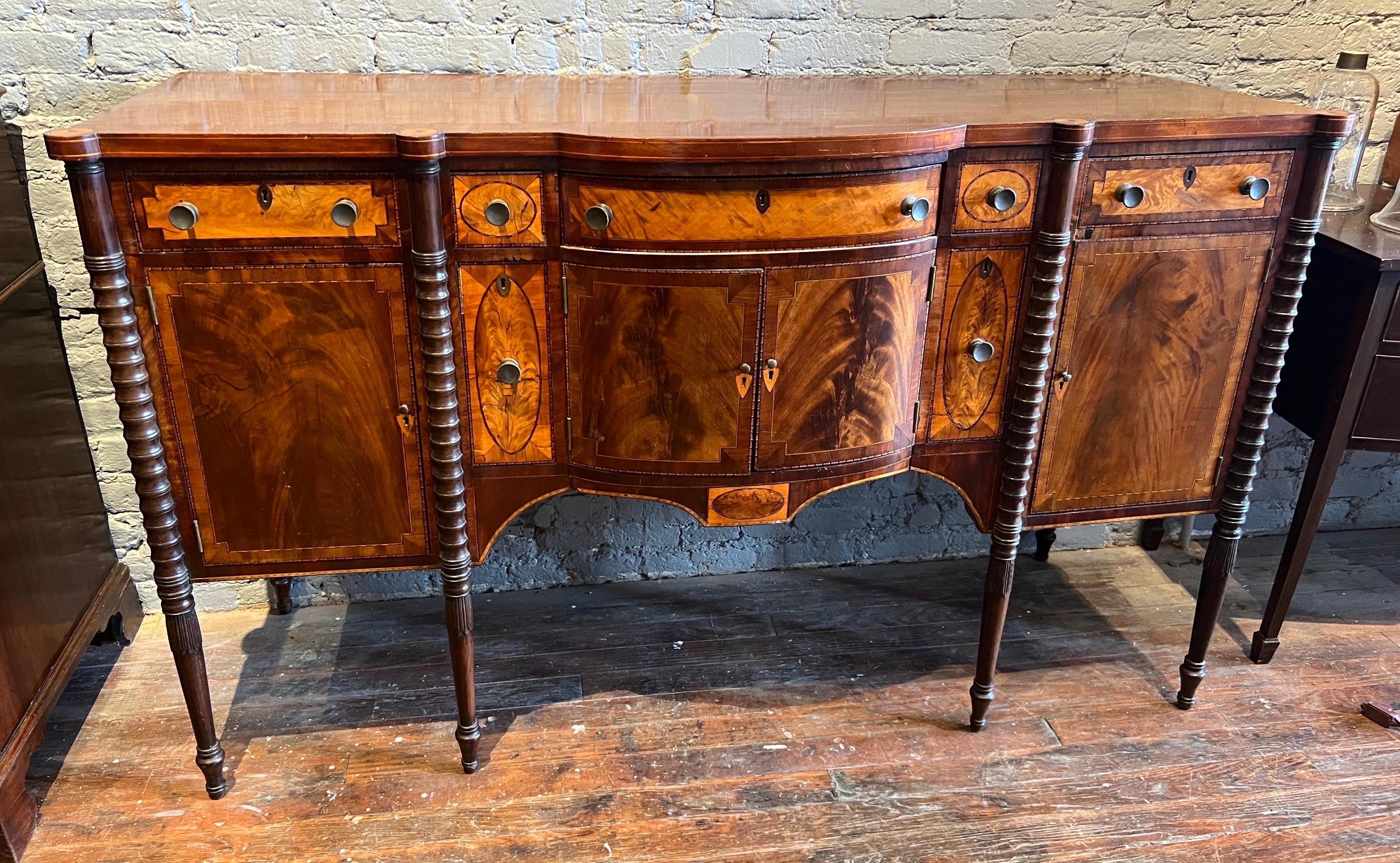 Very fine early 19th century Portsmouth, NH federal inlaid sideboard. Impressive inlays , fine quality crotch veneers, inlaid turrets with sand shading, beautifully turned legs. 