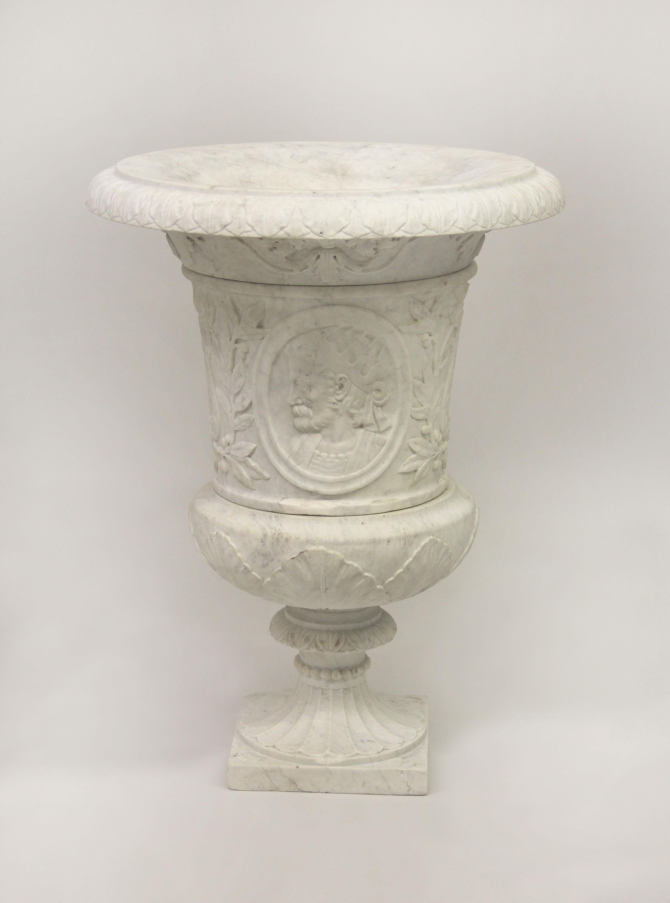 A very fine Early 20th Century hand carved Carrara marble urn

Over sized and intricately designed with a man and woman's face, the sides with a lyre.
    