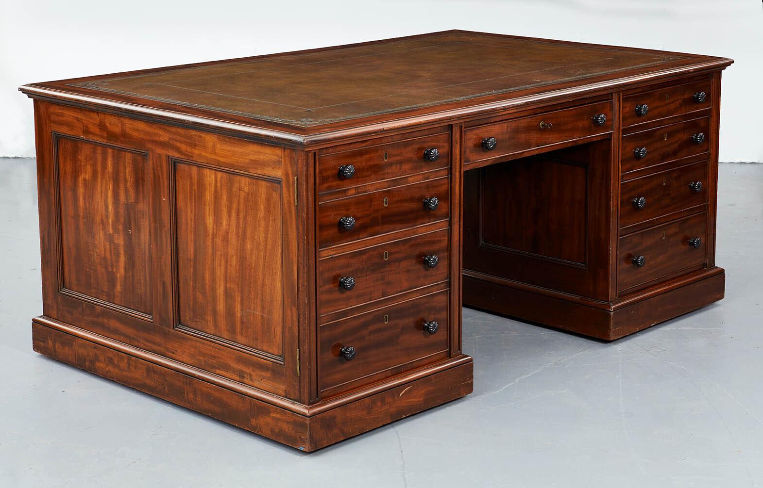 Very fine George IV mahogany and ebony partners desk by Gillows of Lancaster, circa 1825, the tooled double border leather top with cross banding and carved edge, over drawers, the center ones with makers stamp and all with original locks, over two