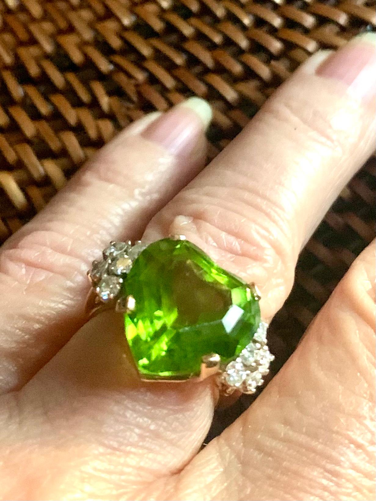 Beautiful, estate 10.5 TCW heart shaped peridot, diamond and 14K yellow gold ring
20th Century
The heart shaped peridot of very fine quality- excellent color, cut, clarity and substantial 10.5 carat weight, surrounded by full cut diamonds,