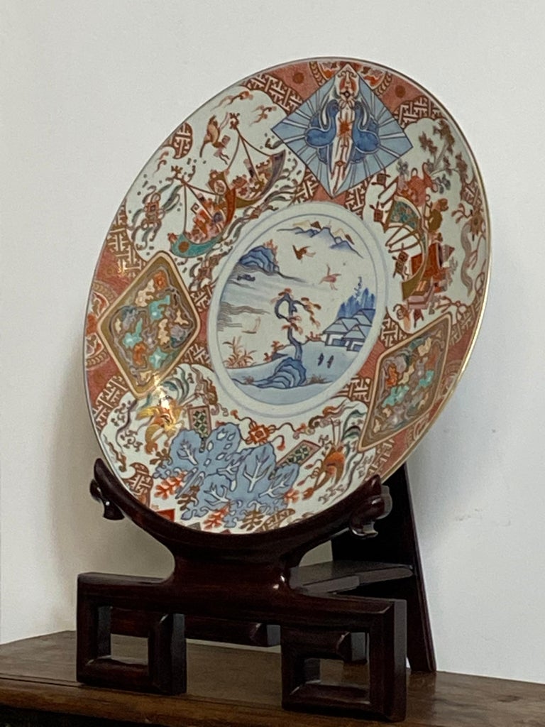 Large Meiji period Imari charger with very finely painted underglaze blue traditional design and overglaze red and gold paint in excellent original condition. 
Japan, Late 19th century circa 1880
Price does not include the stand.